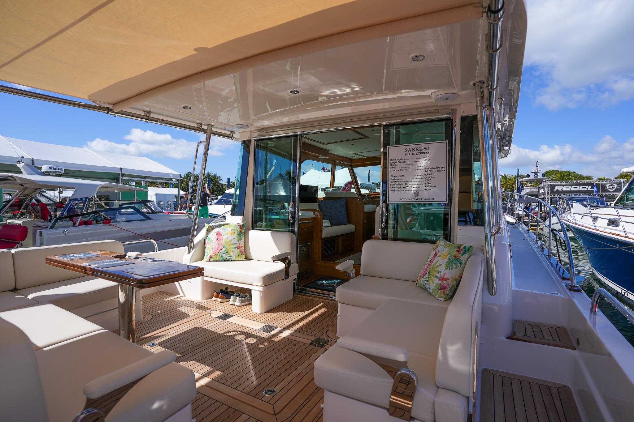 Luxurious 2026 Sabre 51 Salon Express yacht interior with elegant seating and wooden deck.