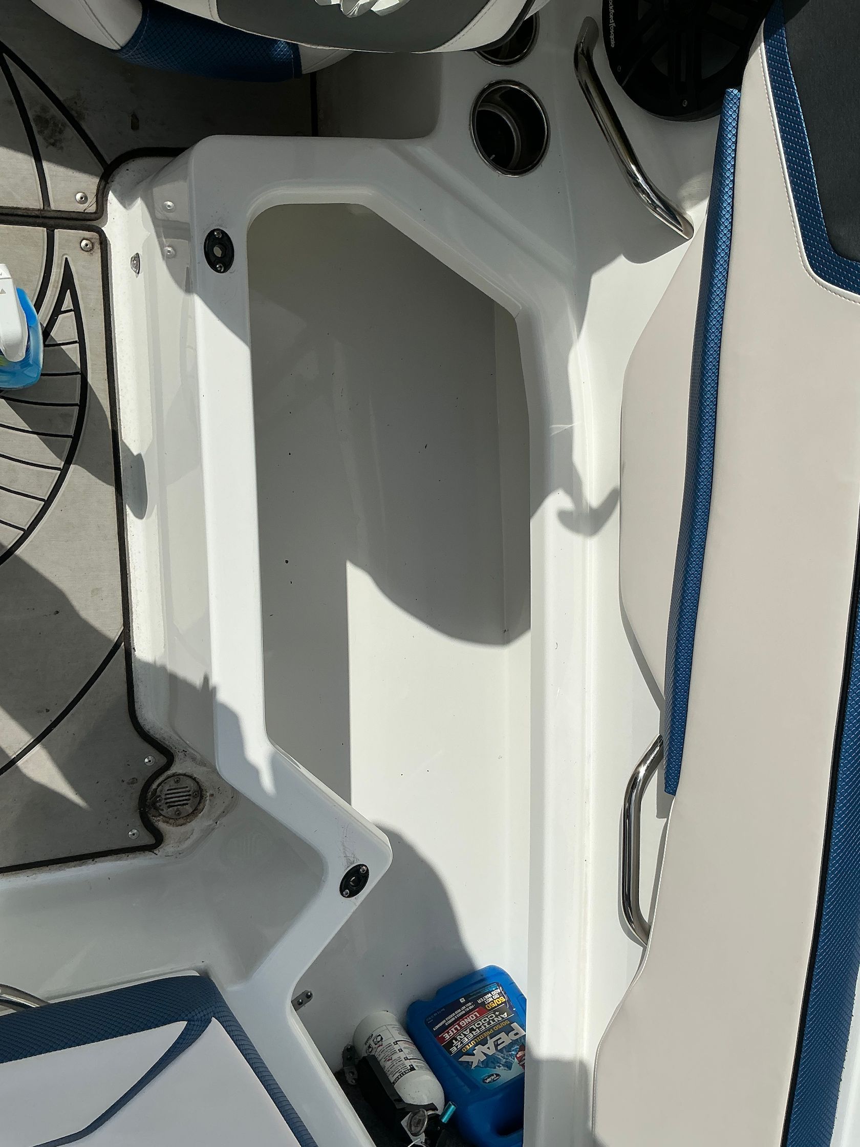 Interior of a 2021 Scarab 215 ID boat with storage compartment.