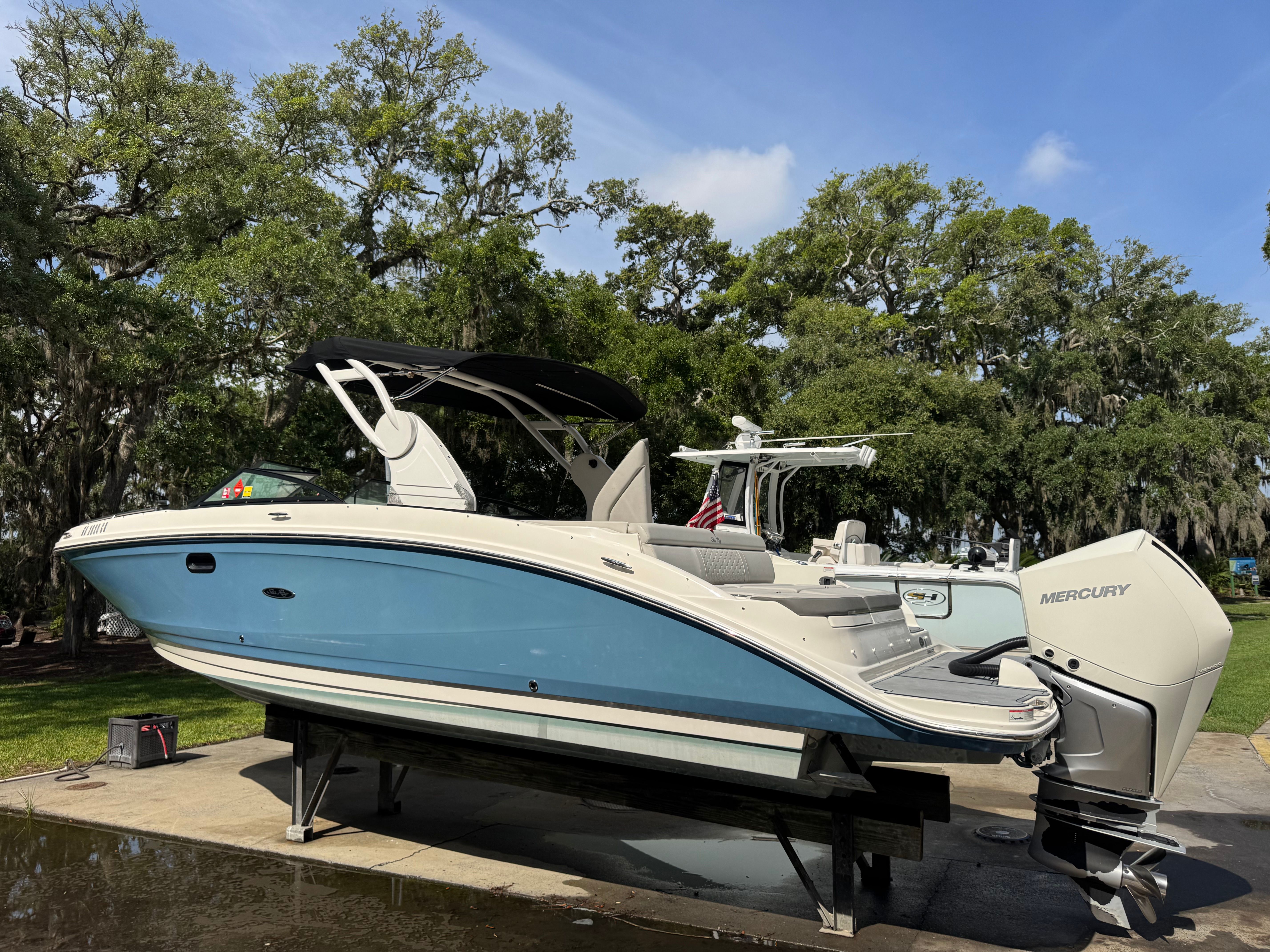 2020 Sea Ray SDX 270 Outboard boat on a trailer outdoors.