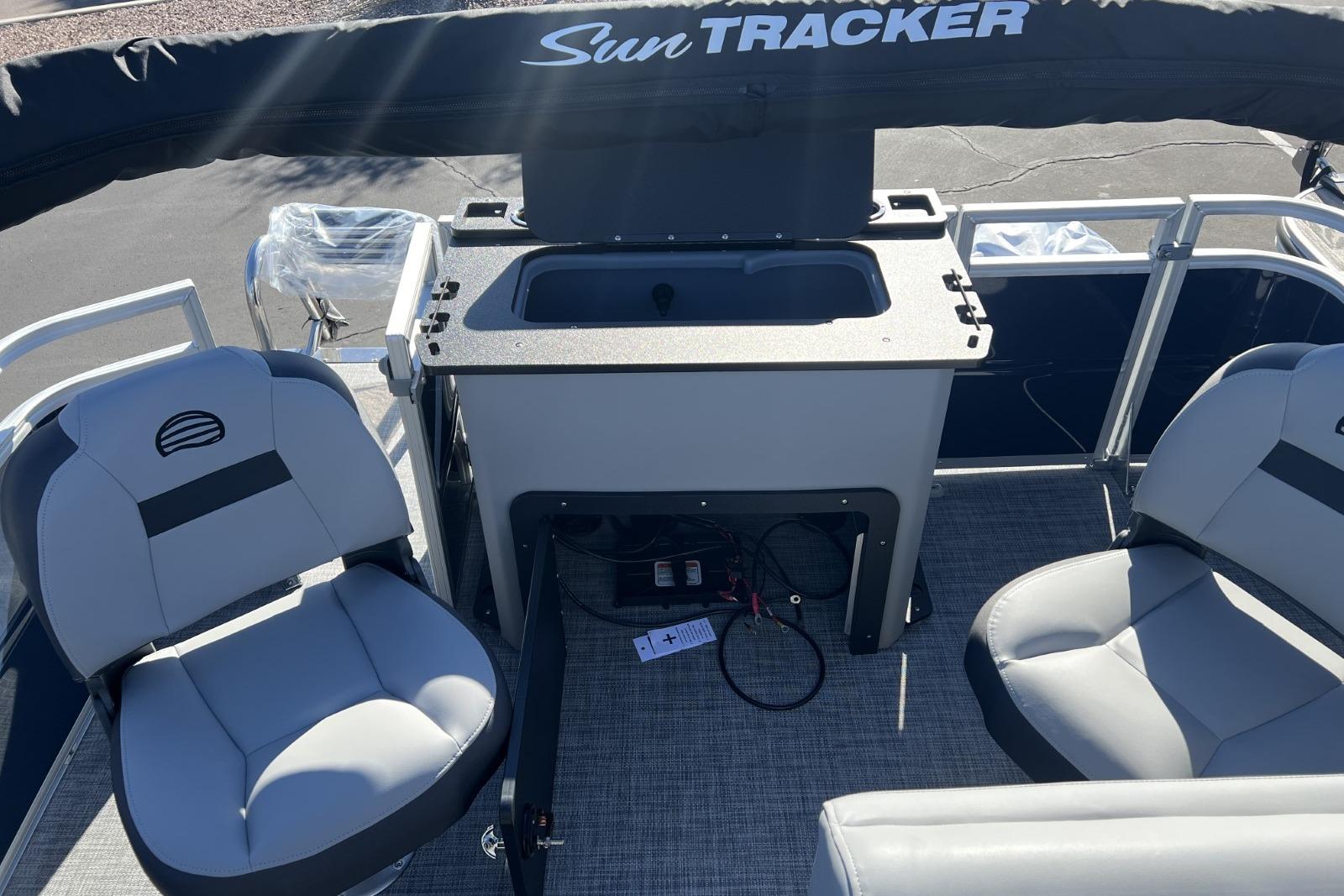 2026 Sun Tracker SportFish 22 DLX boat interior with seating and storage area.