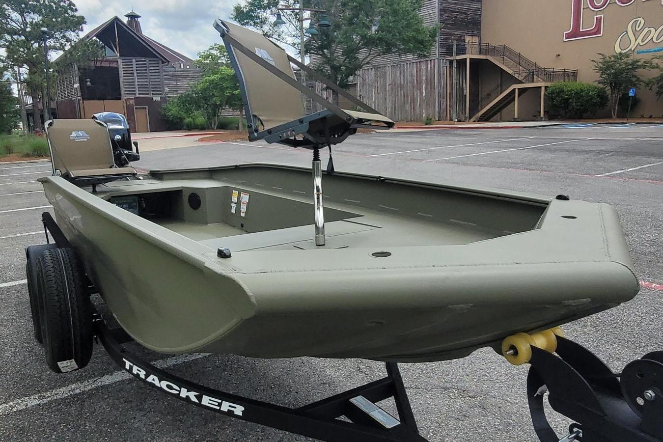 2026 Tracker Grizzly 1650 T Prairie Wings Edition boat on trailer in parking lot.