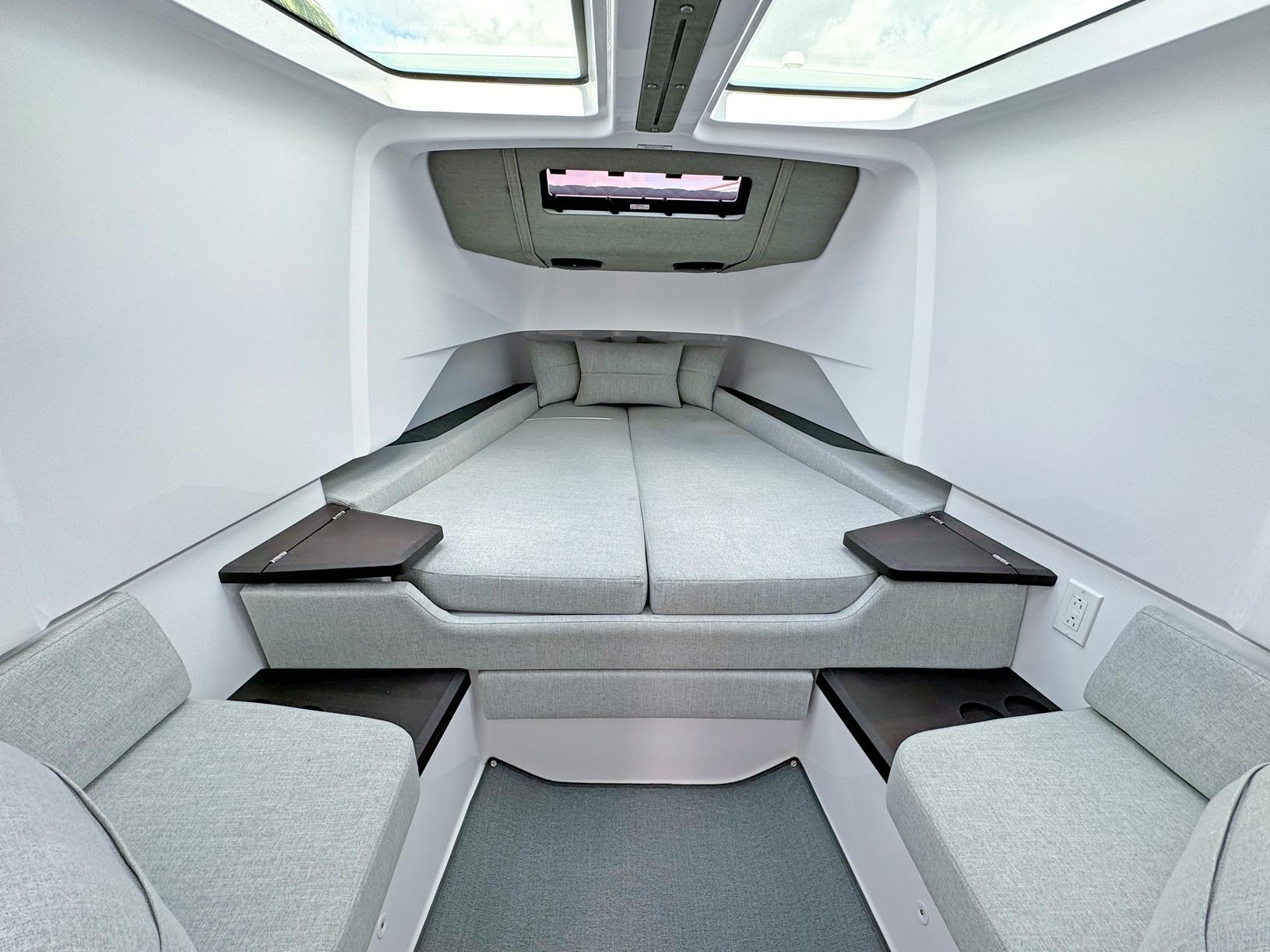 2024 Axopar 37XC CROSS CABIN interior with modern, spacious sleeping area and skylights.