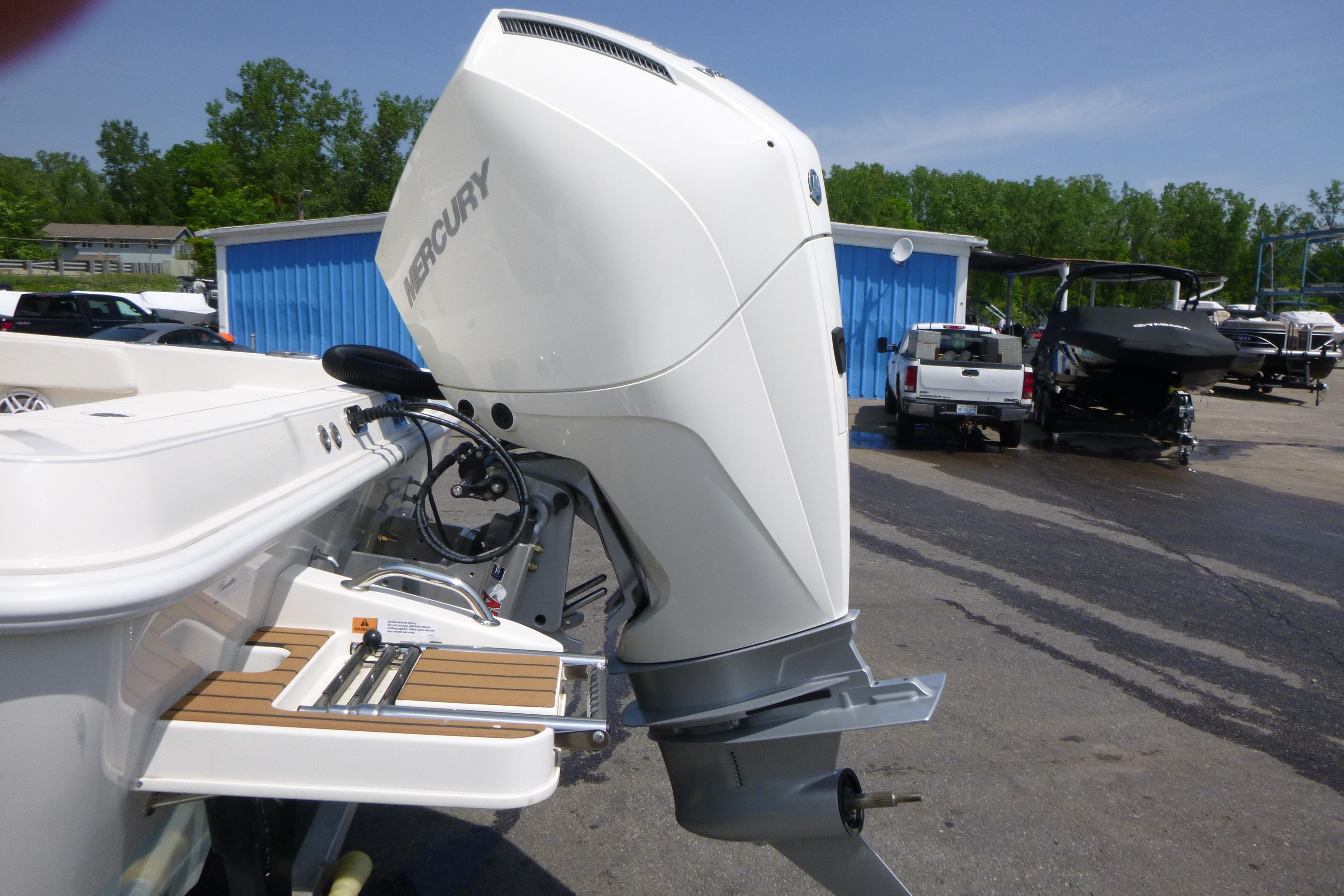 2024 Ranger 2360 Bay boat with Mercury outboard engine at a marina.