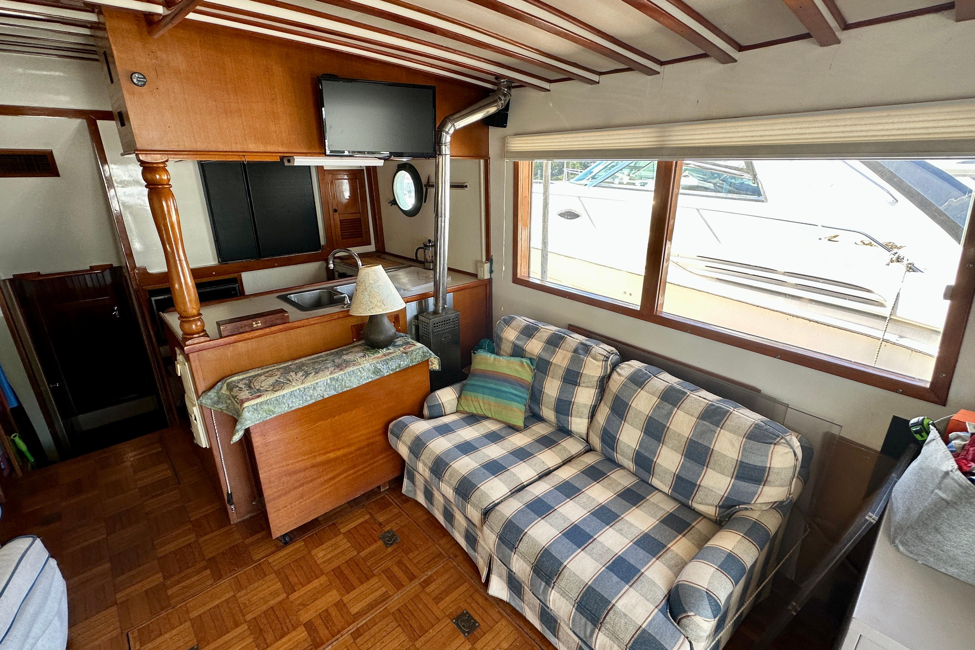 Interior of 1983 Kadey-Krogen Krogen 42 Trawler with cozy seating and kitchenette.