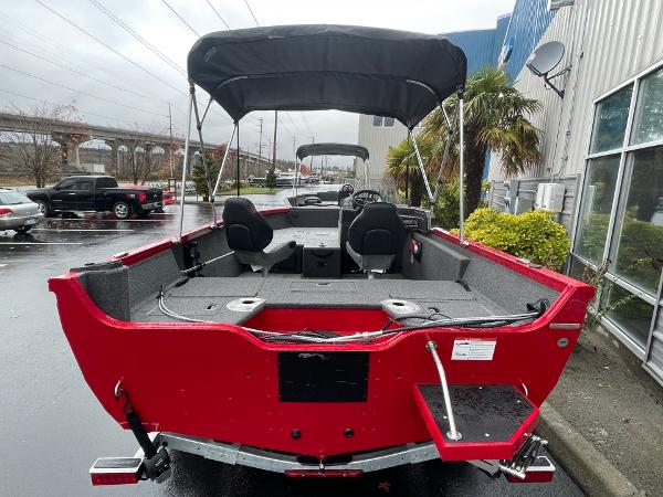 2021 Crestliner 1650 Fish Hawk SC, red boat with canopy, parked outdoors.