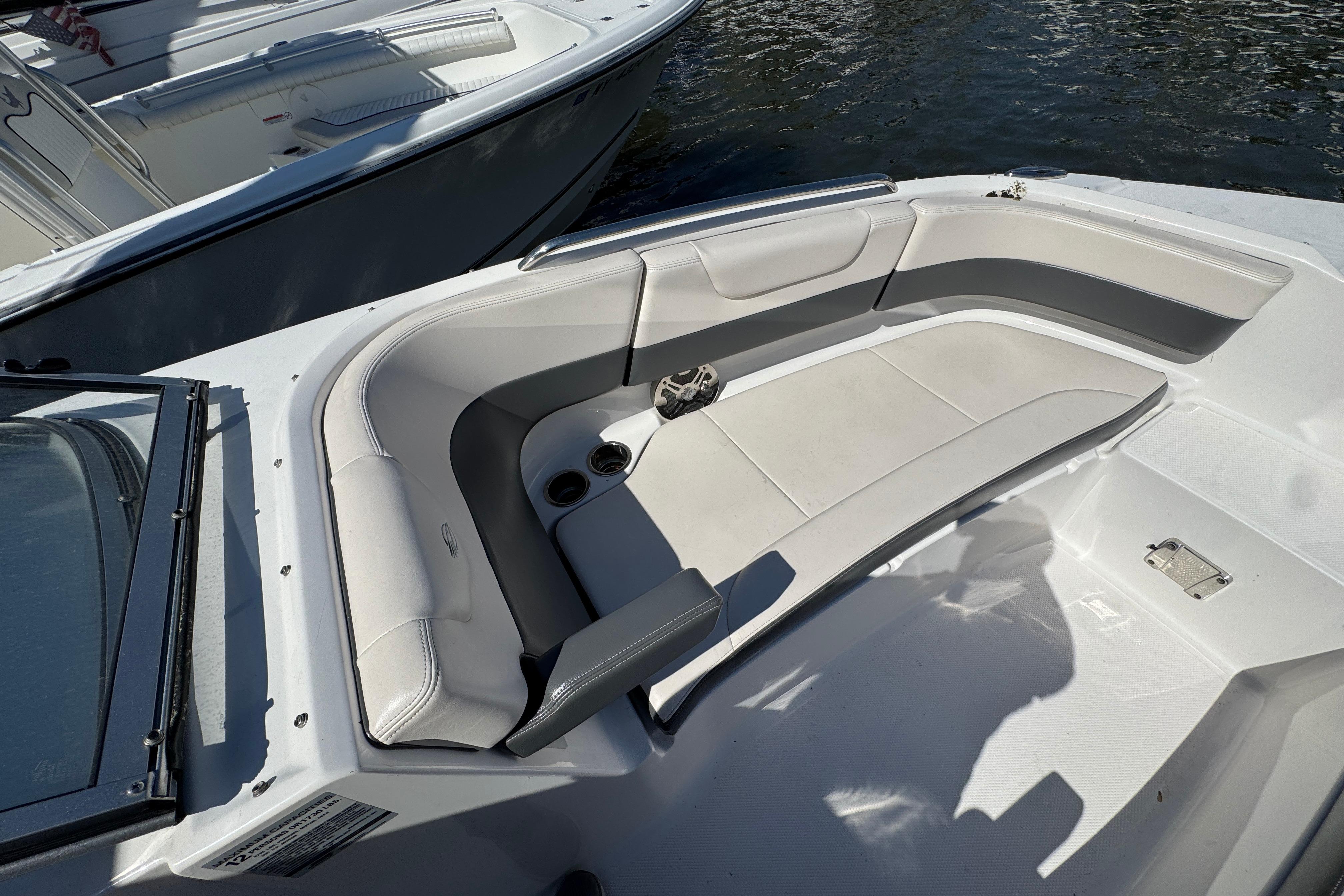 2018 Chaparral 250 Suncoast boat interior with cushioned seating and cup holders.