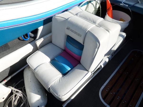 1992 Rinker Captiva 170 OB boat seat with colorful cushions and nautical accessories.