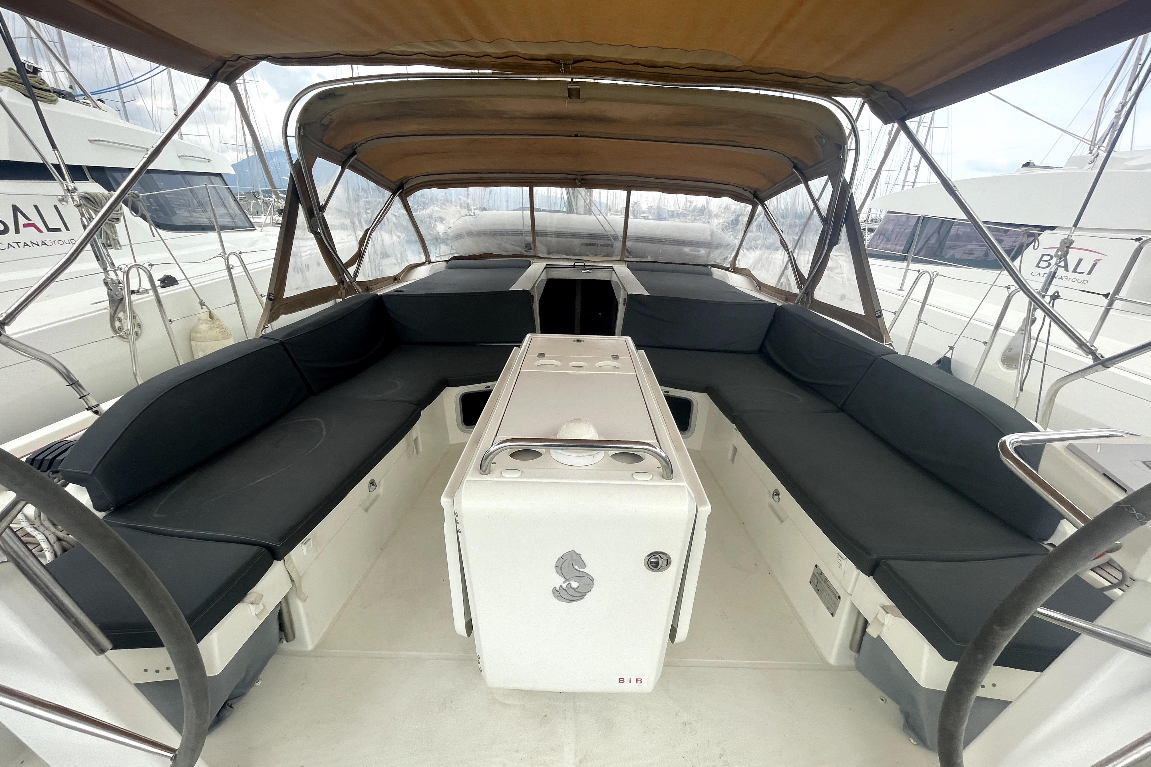 Spacious cockpit of 2018 Beneteau Oceanis 51.1 yacht with cushioned seating and canopy.