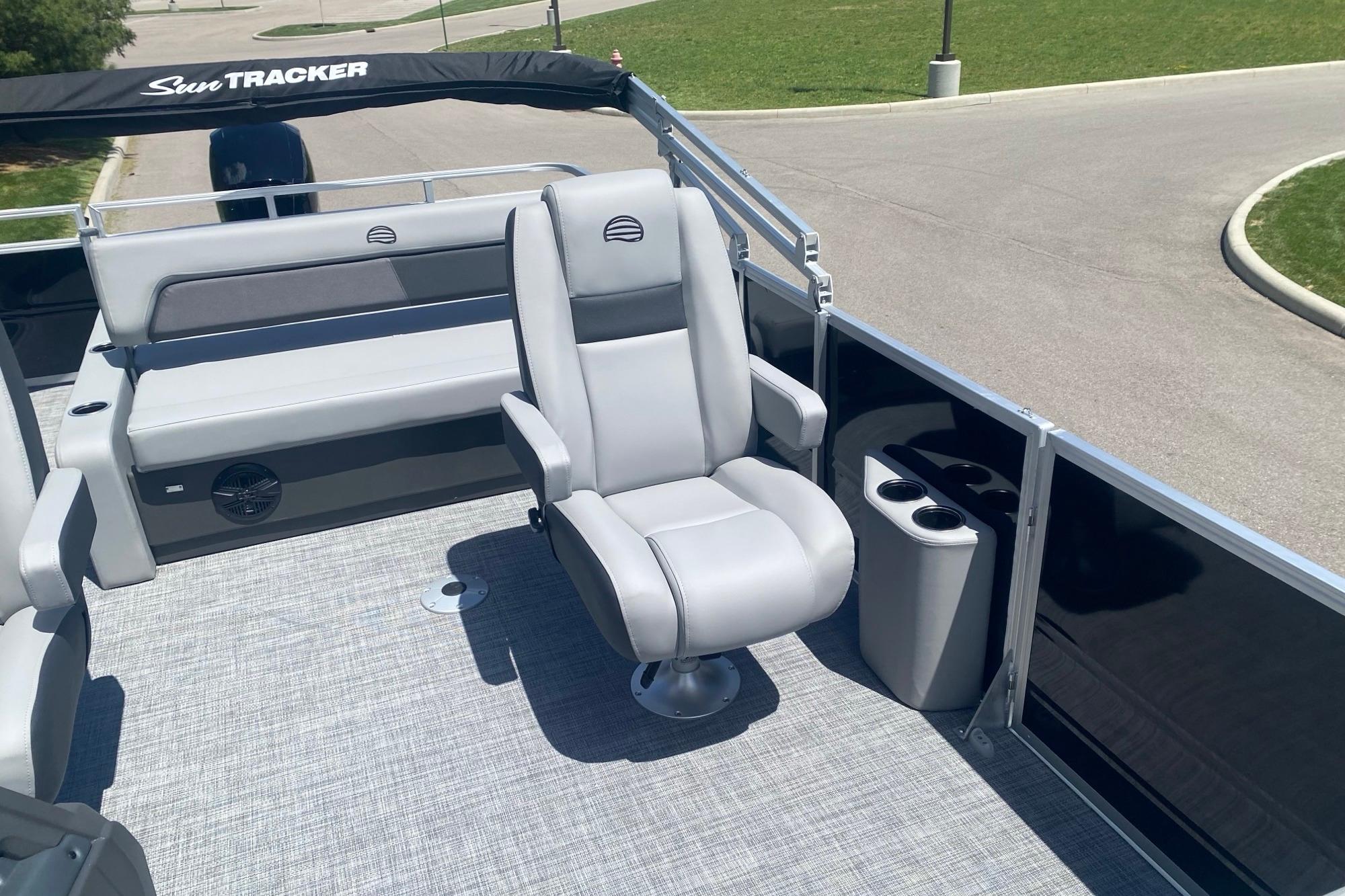 2026 Sun Tracker Party Barge 22 RF DLX interior with plush seating and cup holders.
