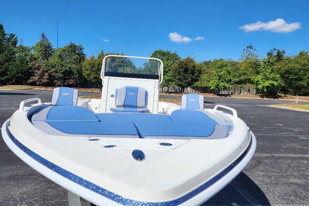 2025 Ranger 2510 Bay boat with blue seating, parked outdoors under clear sky.