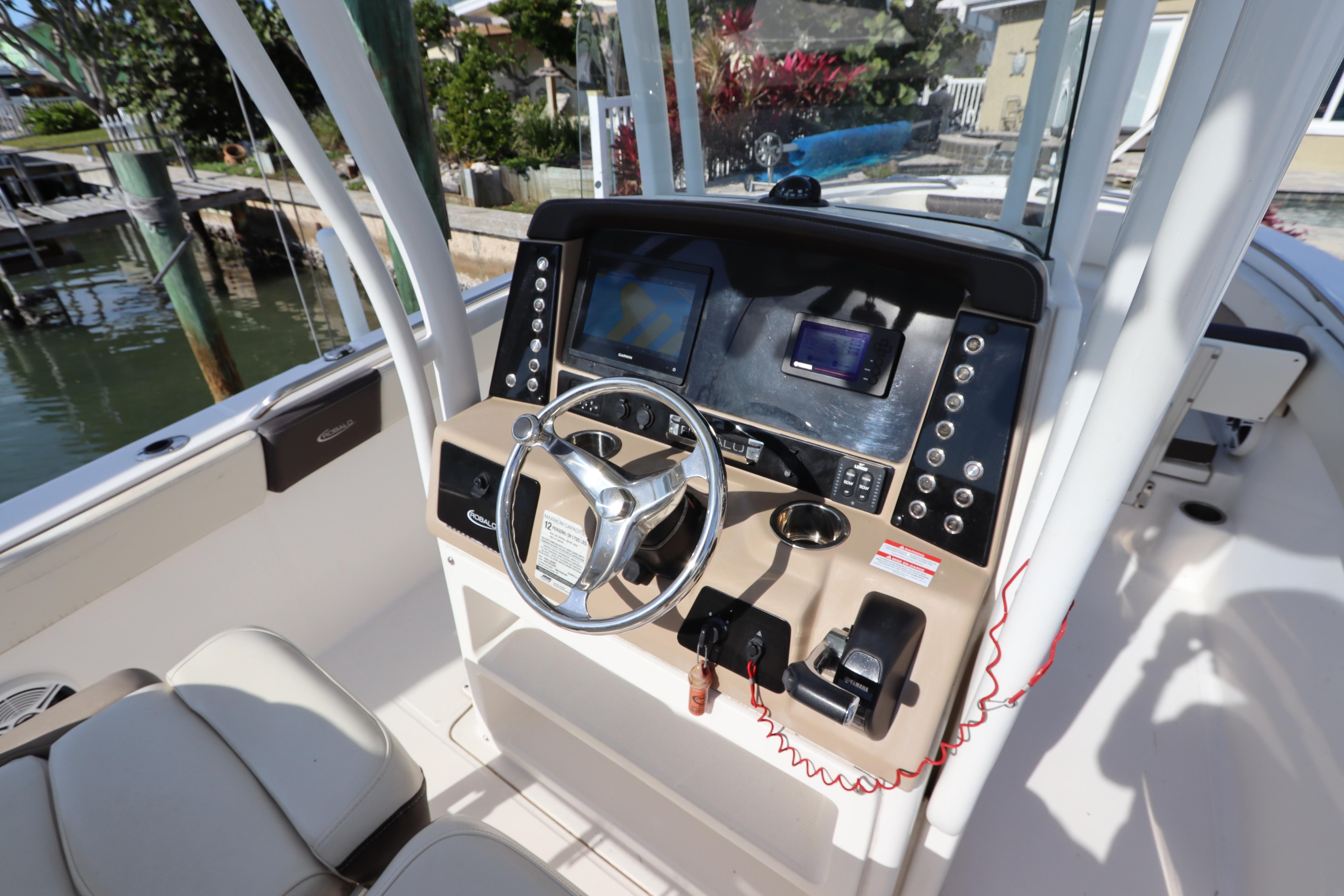 2019 Robalo R242 Center Console boat dashboard with steering wheel and navigation controls.