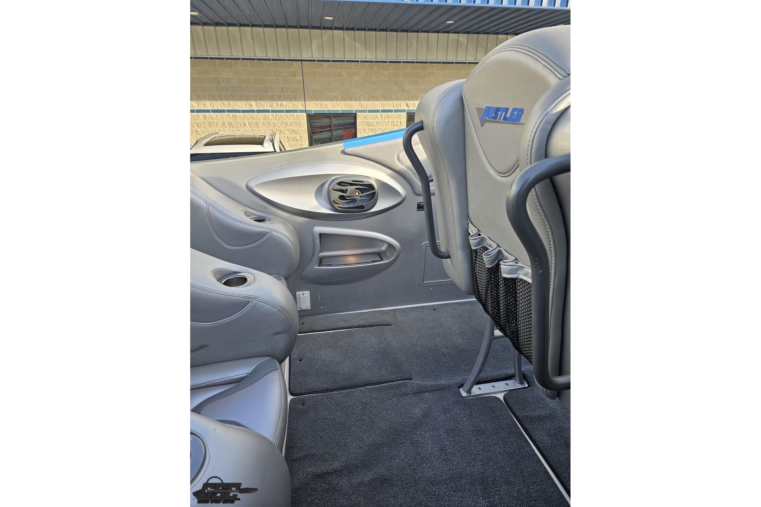 Interior of 2007 Hustler 41 Razor boat with gray seating and storage compartments.