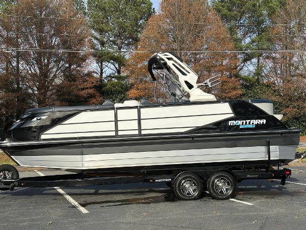 2025 Montara Surf Boss 2.0 25 boat on trailer, parked outdoors.