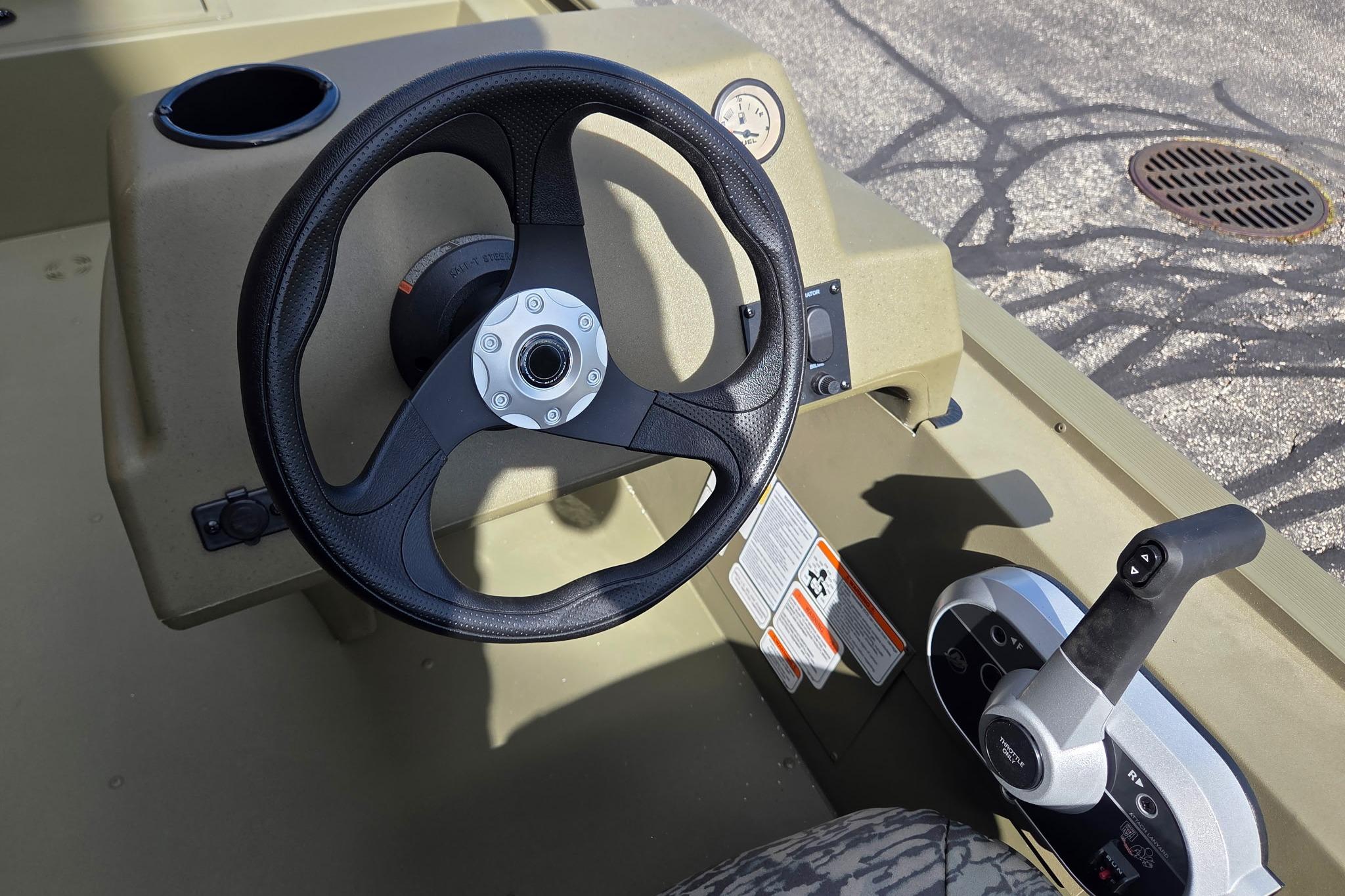 Steering console of 2026 Tracker Grizzly 1754 SC boat, featuring controls and gauges.