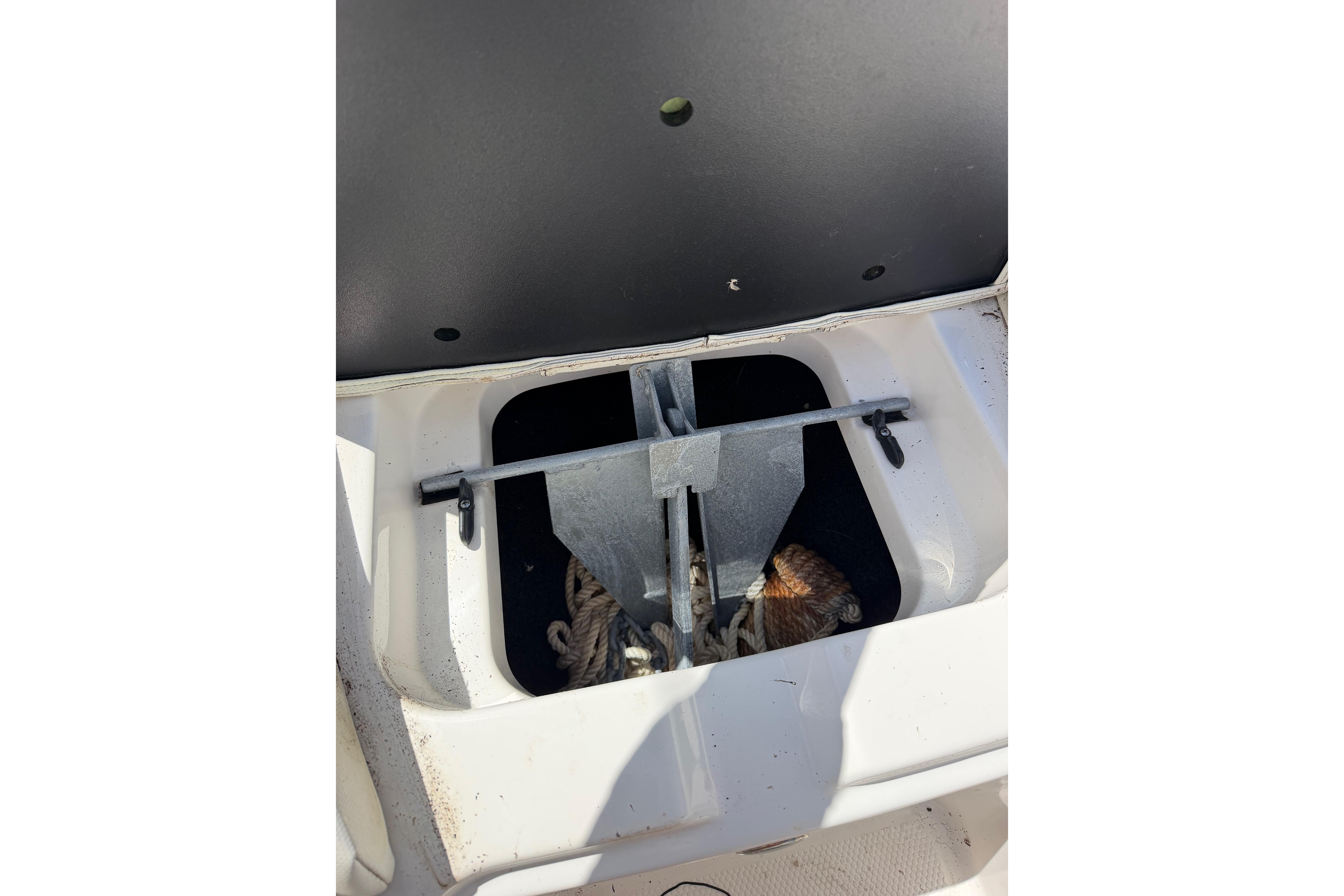 2023 MasterCraft X24 boat anchor storage compartment with visible ropes and hardware.