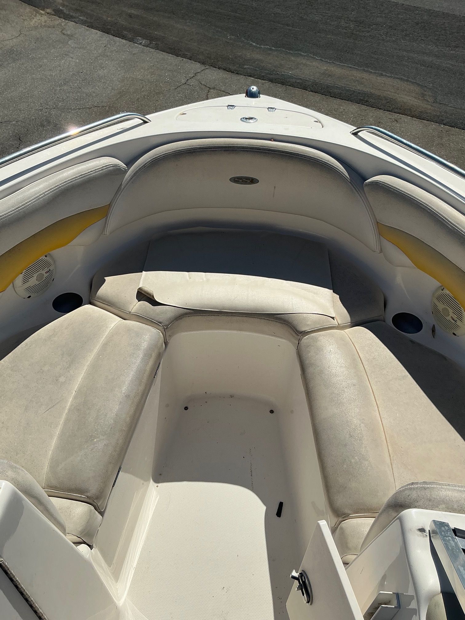 The image shows the bow area of a 2003 Chaparral 210 SS boat with cushioned seating.