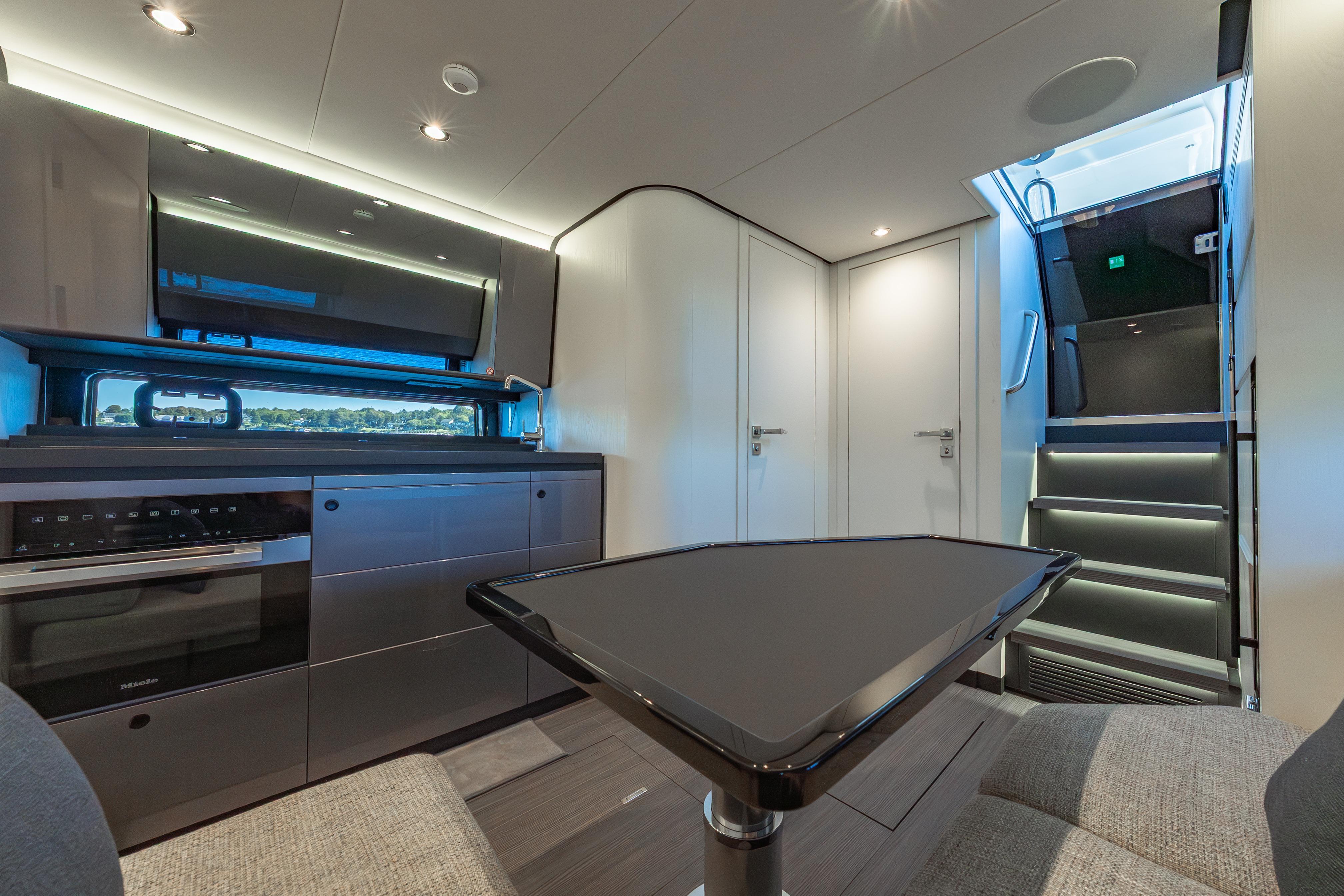 Luxurious interior of 2023 Azimut Verve 47 yacht, featuring modern kitchen and sleek design.