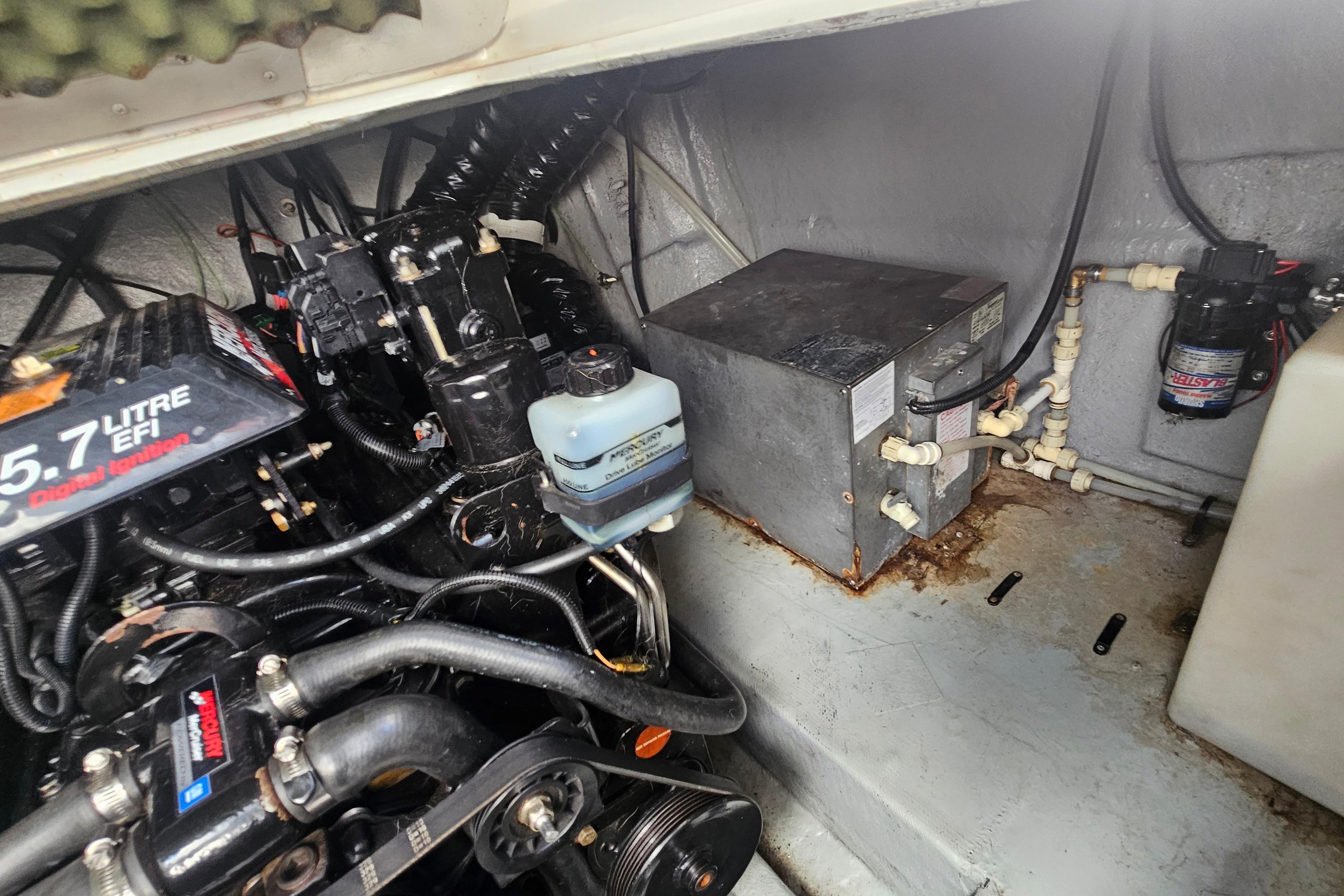 Engine compartment of a 2000 Crownline 242 CR boat, featuring a 5.7-liter EFI engine.