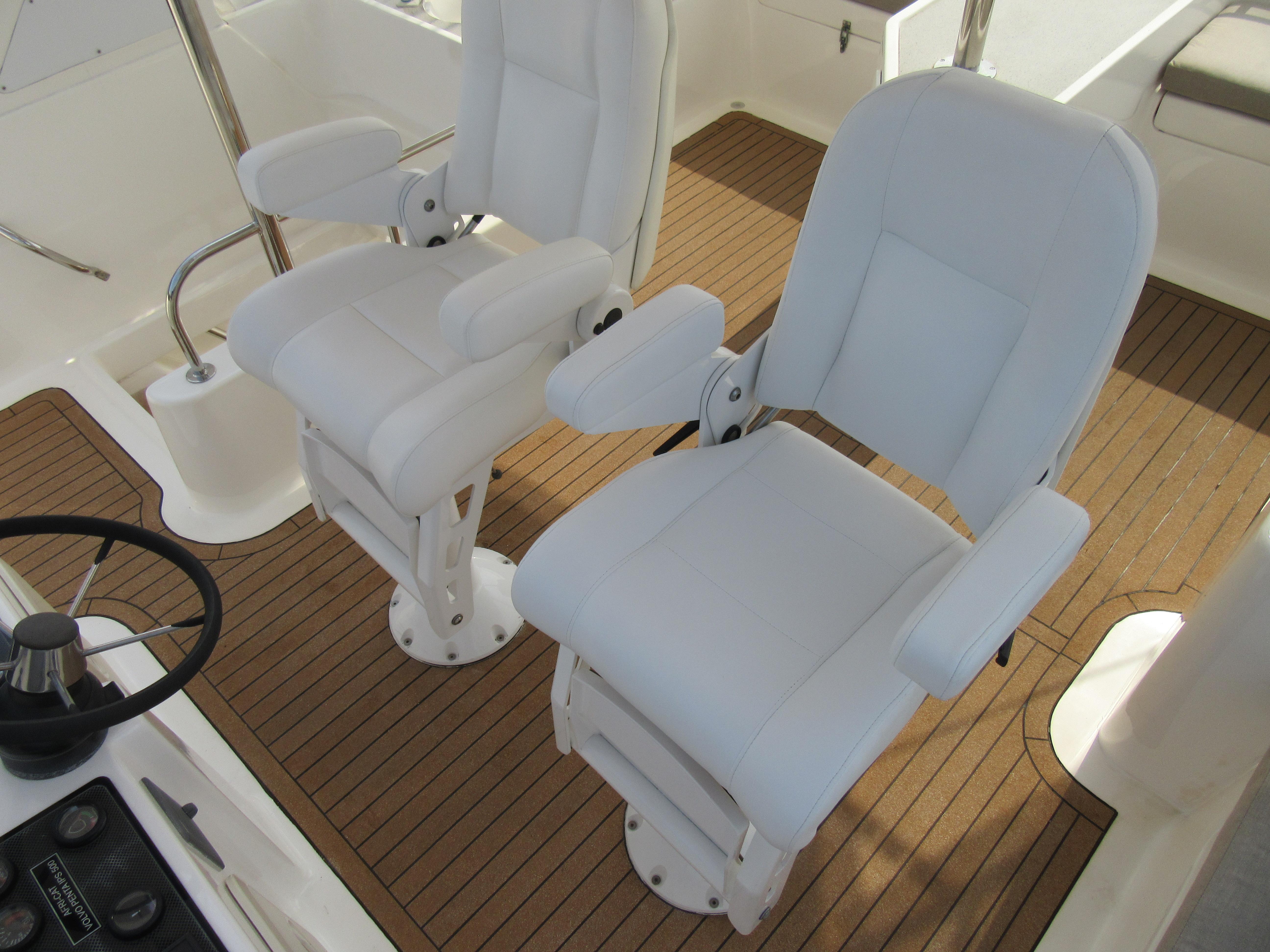White captain chairs on Africat Marine 420 yacht, 2008 model, with teak flooring.