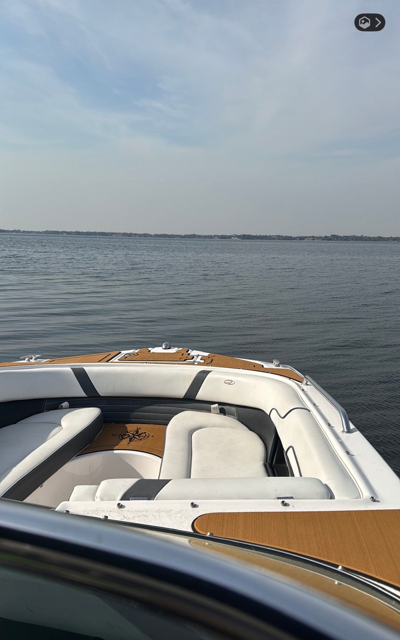 Regal 27 FasDeck 2016 on calm water under clear sky.