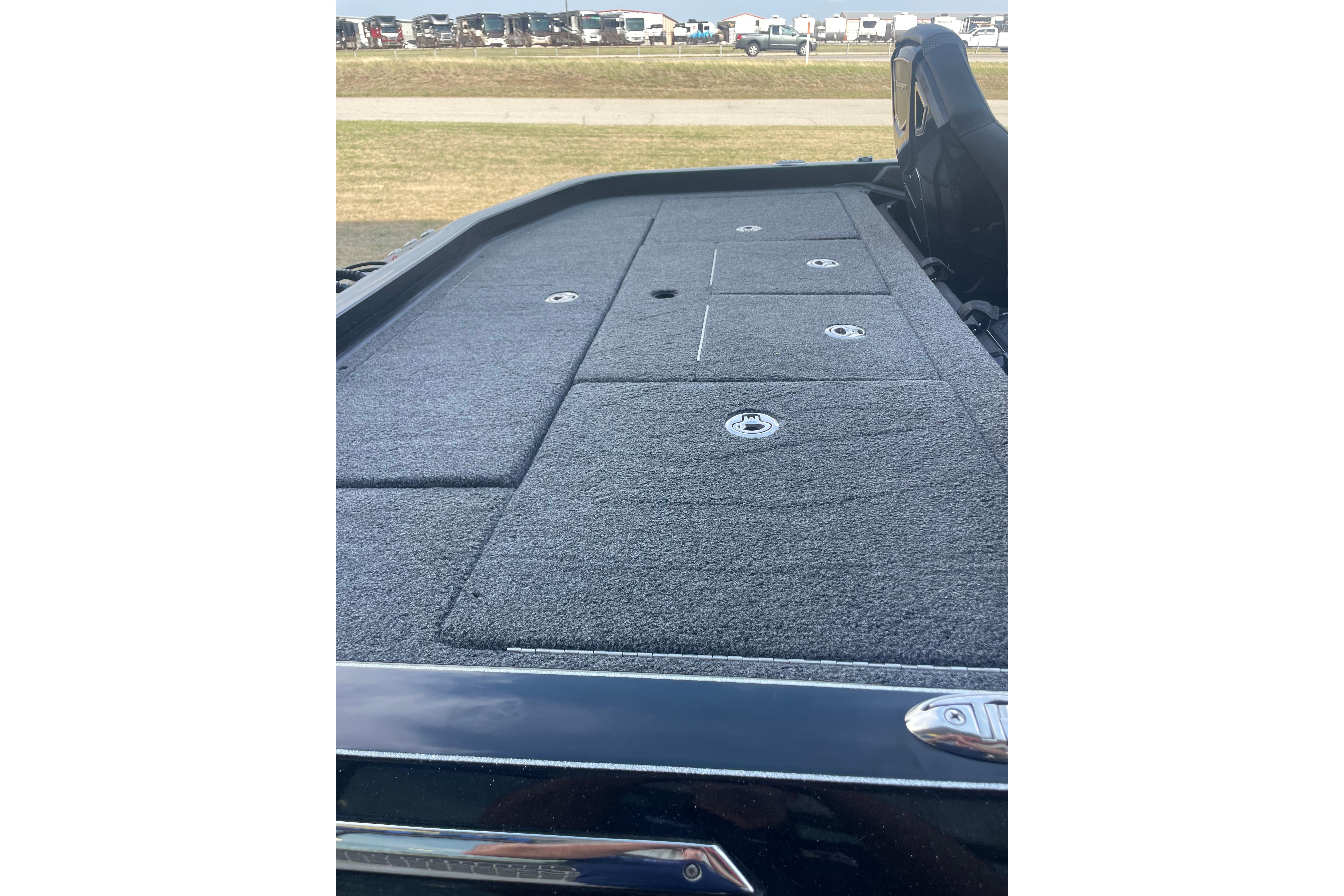 2023 Ranger Z521R boat deck with storage compartments, featuring a sleek, carpeted surface.