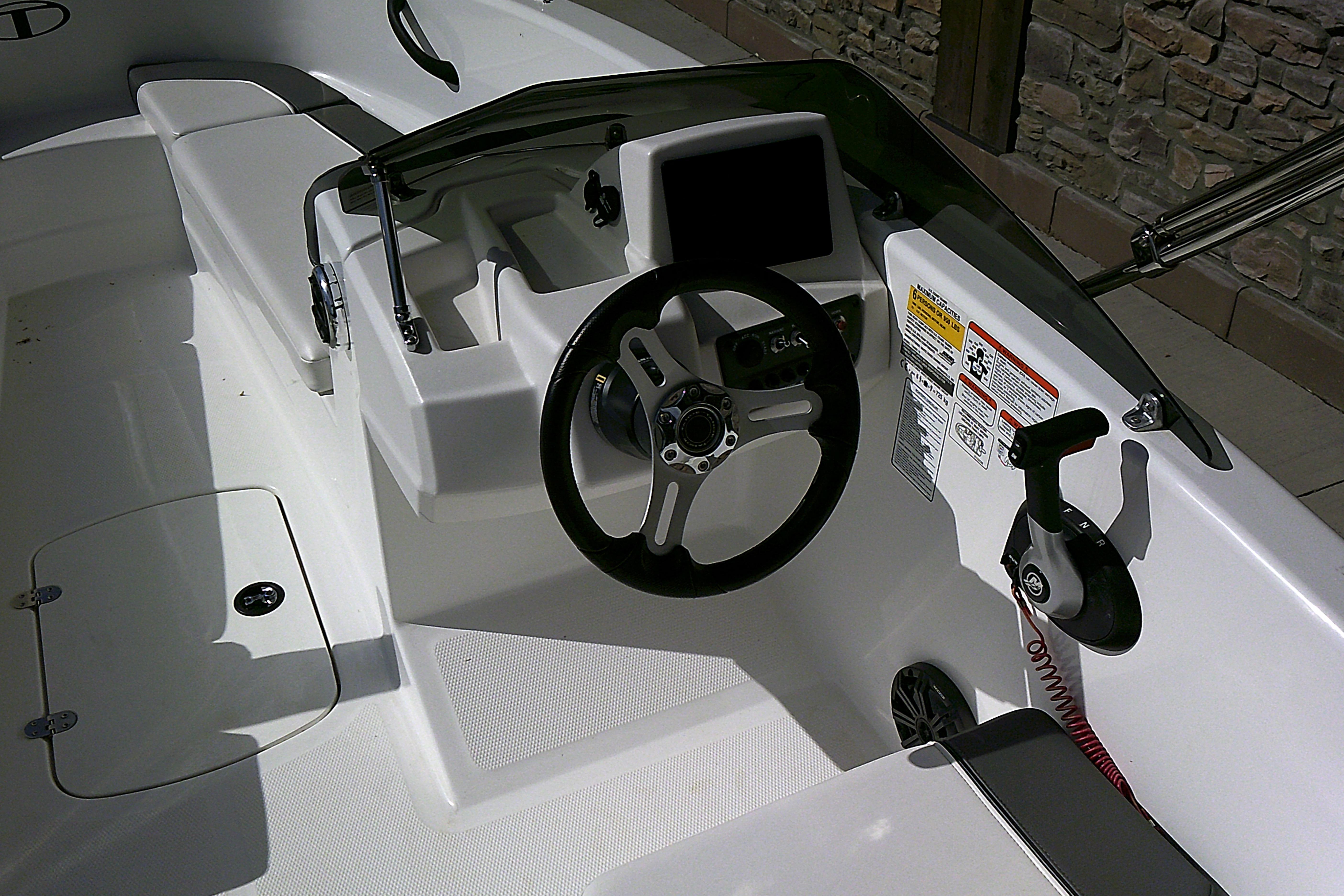 2025 Tahoe T16 boat cockpit with steering wheel and control panel.