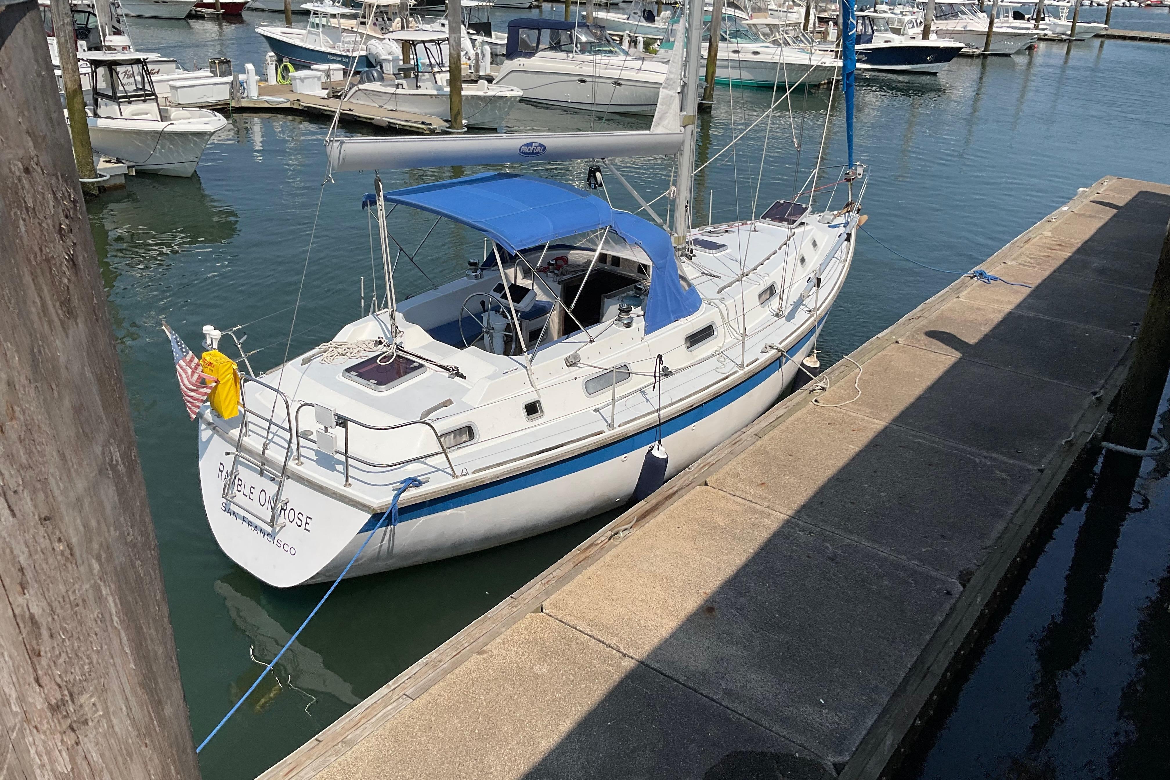 1988 Westerly Corsair 36 sailboat docked in a marina, featuring a blue canopy.