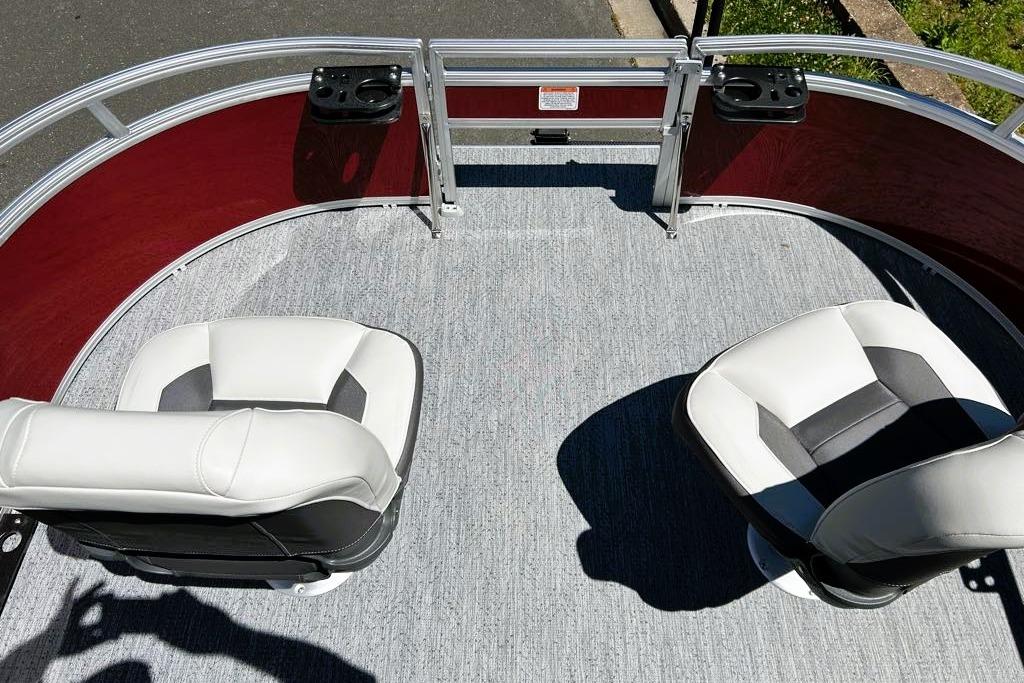2026 Sun Tracker Bass Buggy 16 XL Select pontoon boat with two cushioned seats and cup holders.