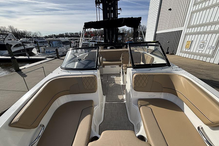 2023 Bayliner VR5 Bowrider OB with tan seating, docked at a marina.