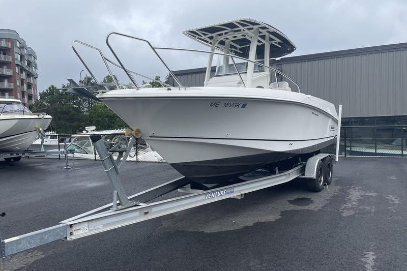 2012 Boston Whaler 250 Outrage on trailer, parked outdoors near buildings.