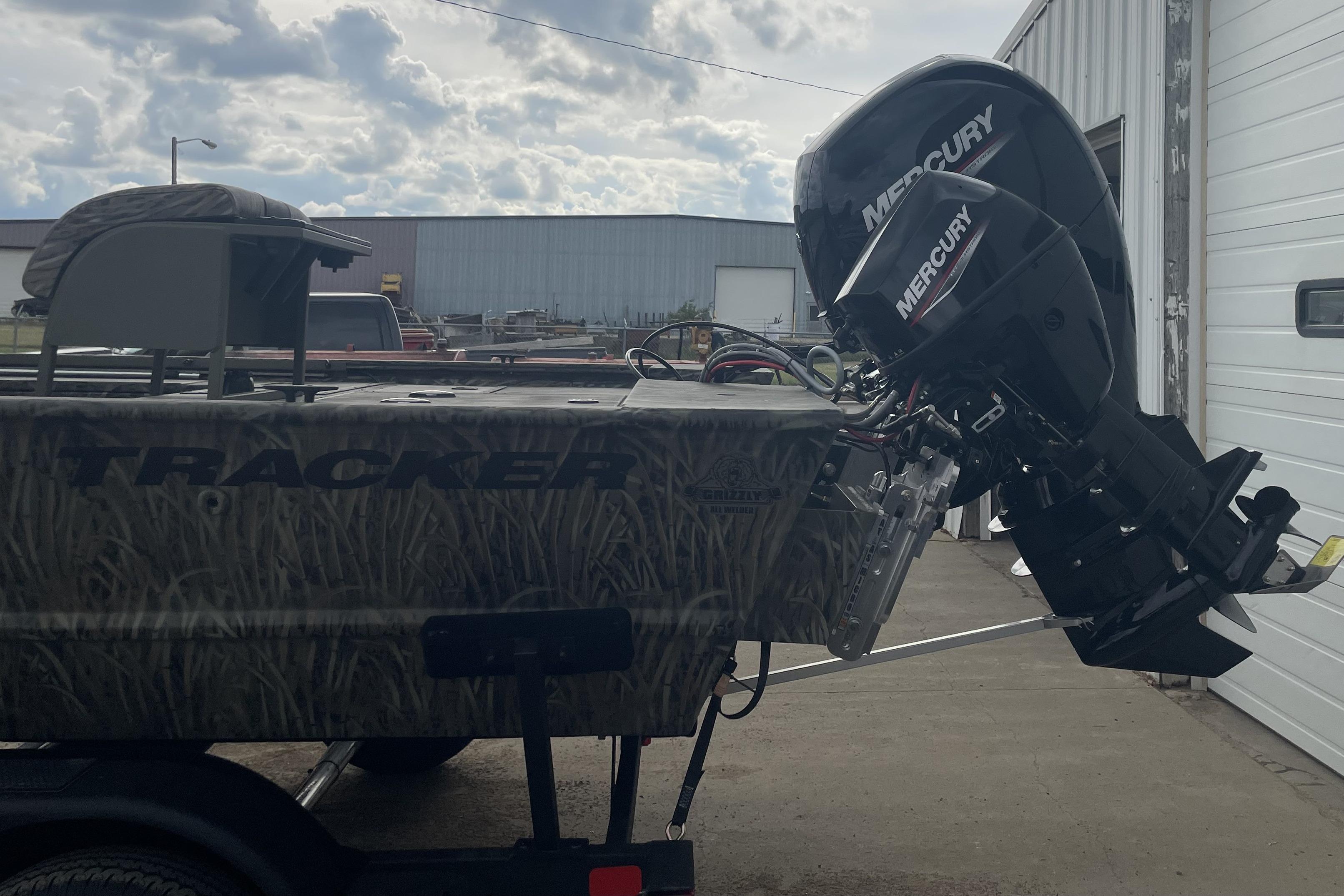2026 Tracker Grizzly 2072 CC Sportsman Kicker boat with Mercury outboard motor.