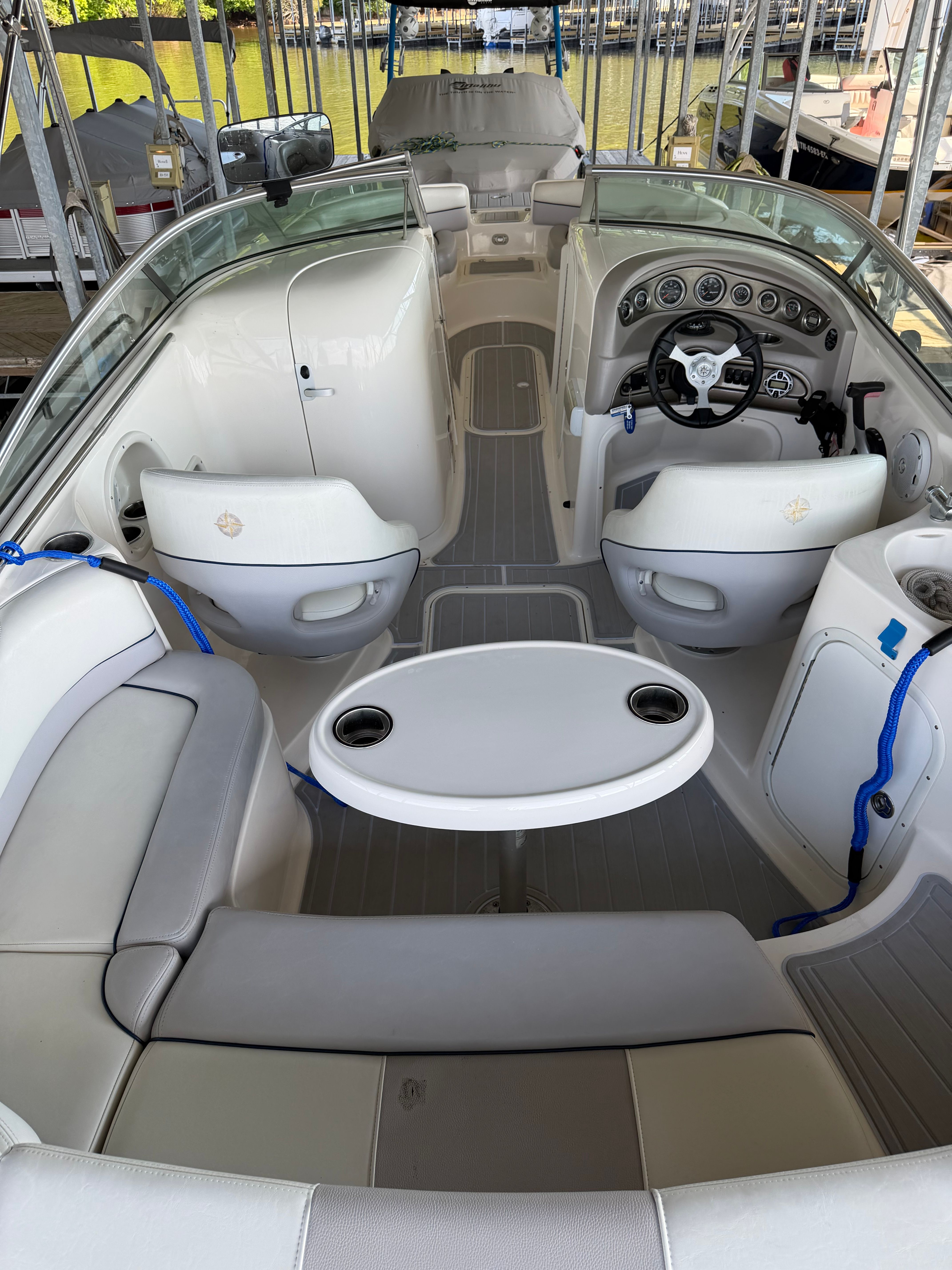 Interior of a 2010 Bryant 255 boat with steering wheel and seating.
