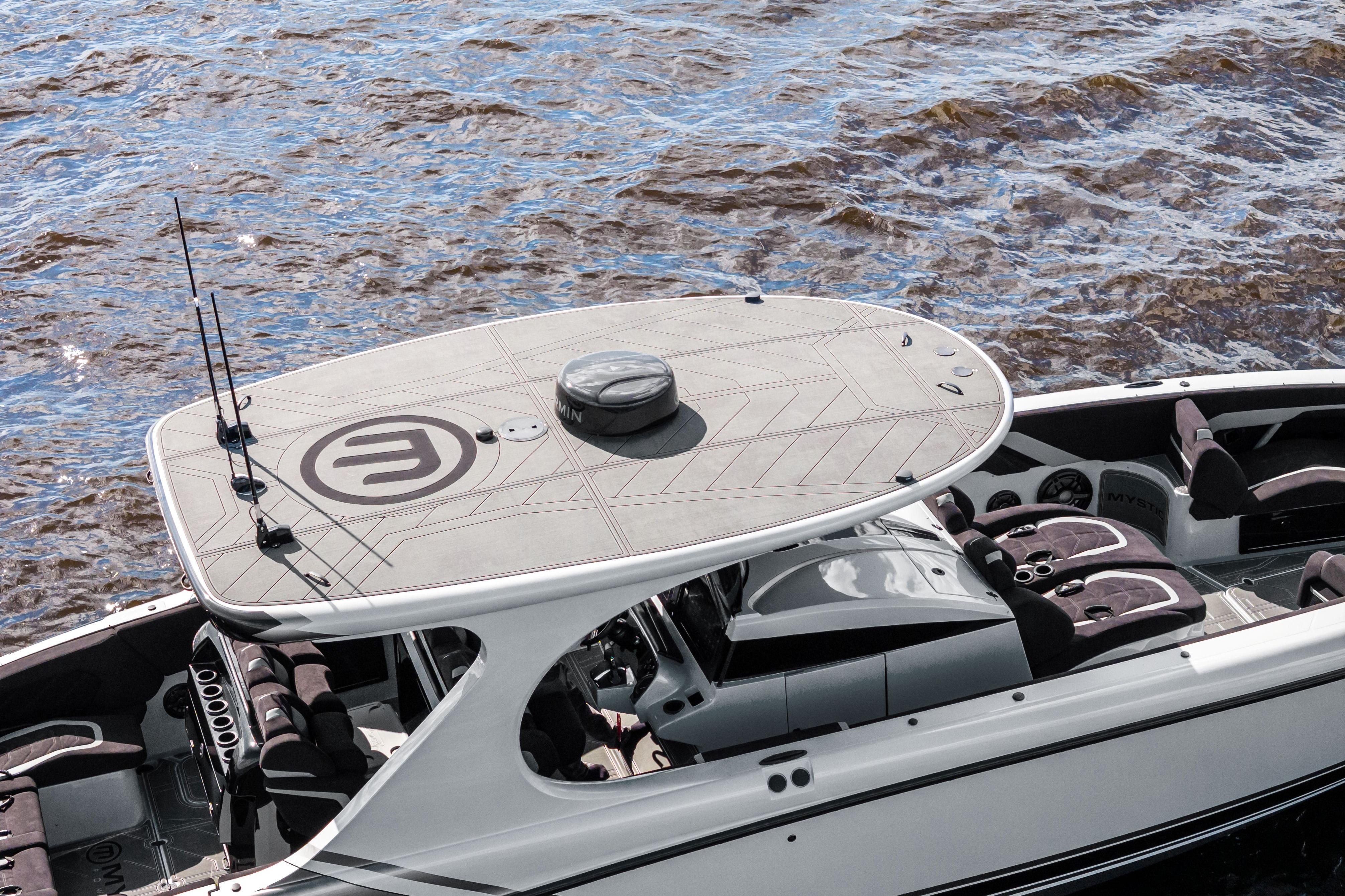 2027 Mystic Powerboats M4200 on water, showcasing sleek design and spacious seating.