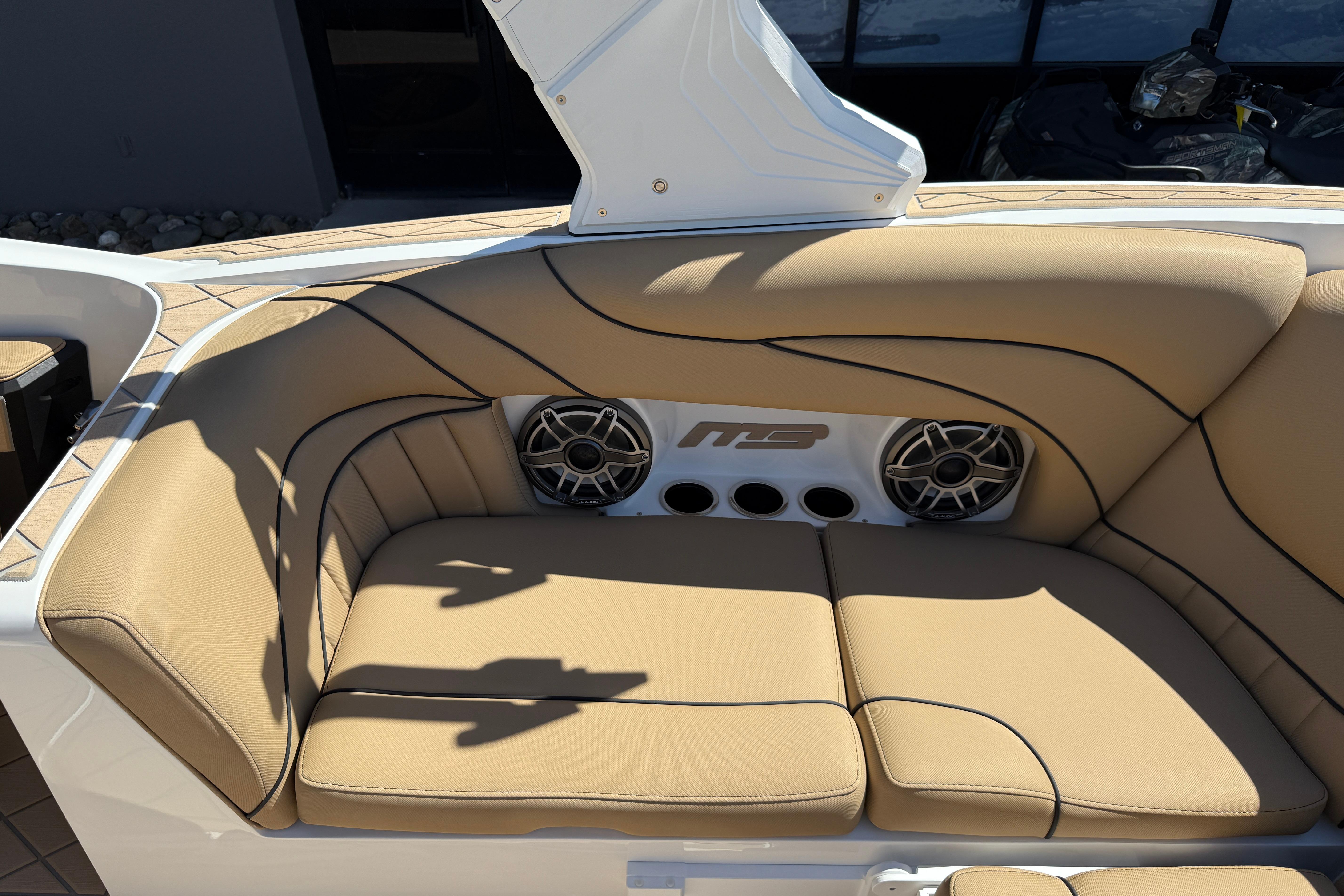 Luxurious tan seating with speakers on a 2026 MB B52 23 Alpha boat.