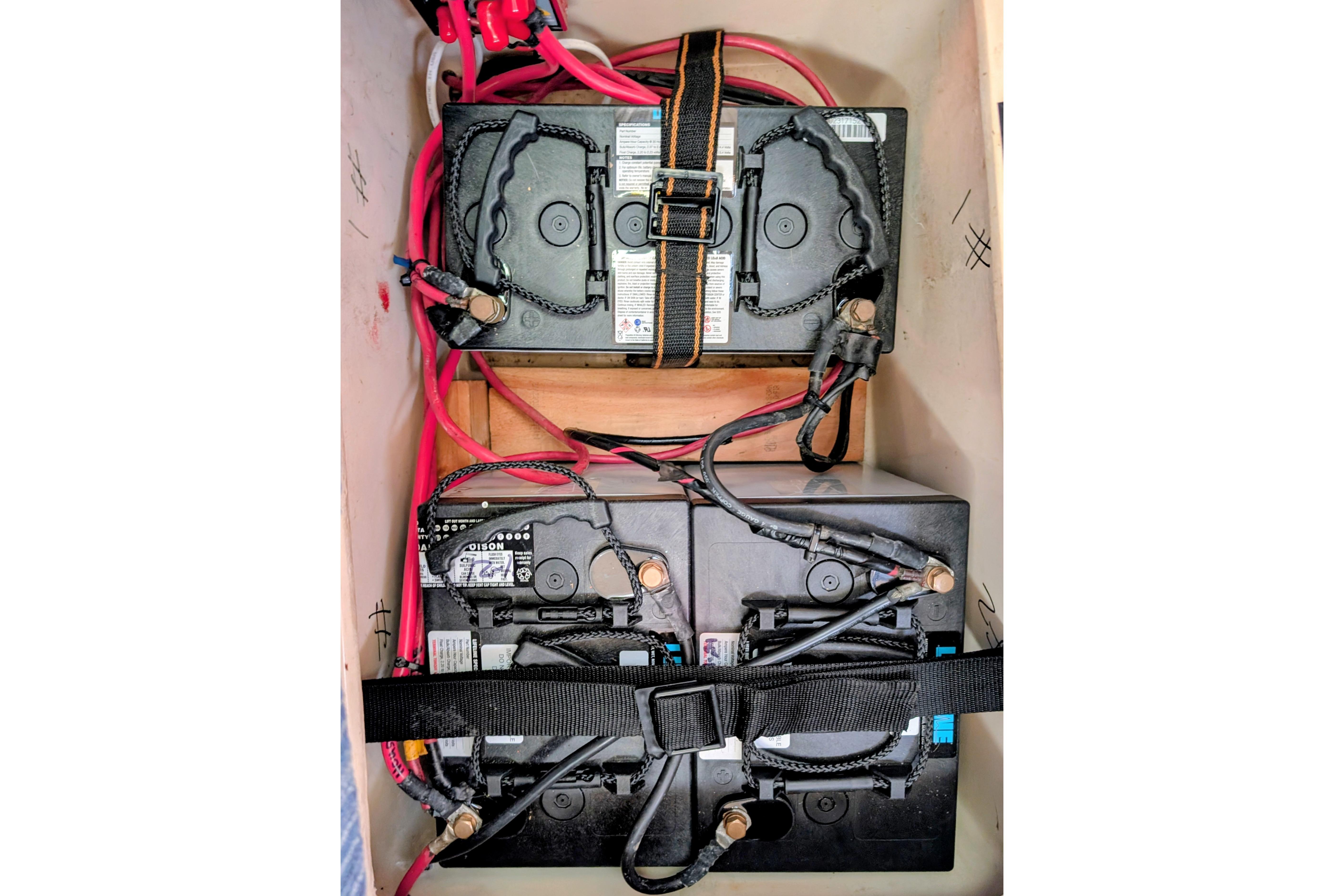 Battery compartment of a 1989 Catalina 34 sailboat with secured wiring.