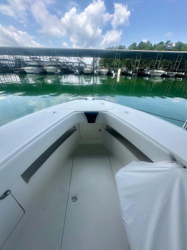 2008 SeaVee 390B boat docked, showcasing spacious deck and serene marina backdrop.