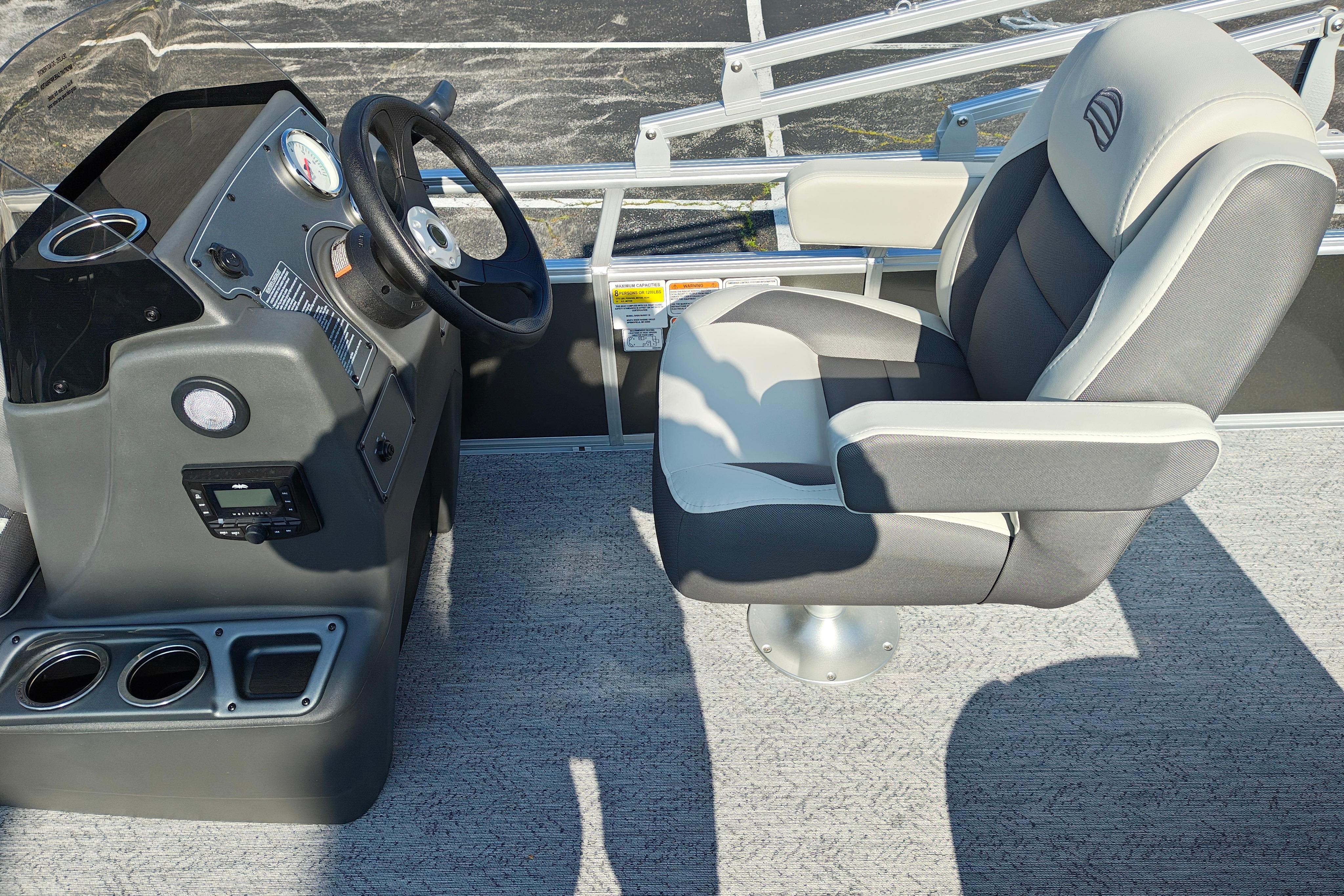 2026 Sun Tracker Bass Buggy 18 DLX boat interior with steering console and captain's chair.