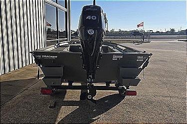 2025 Tracker Grizzly 1654 T Sportsman boat with 40 HP motor, parked outdoors.