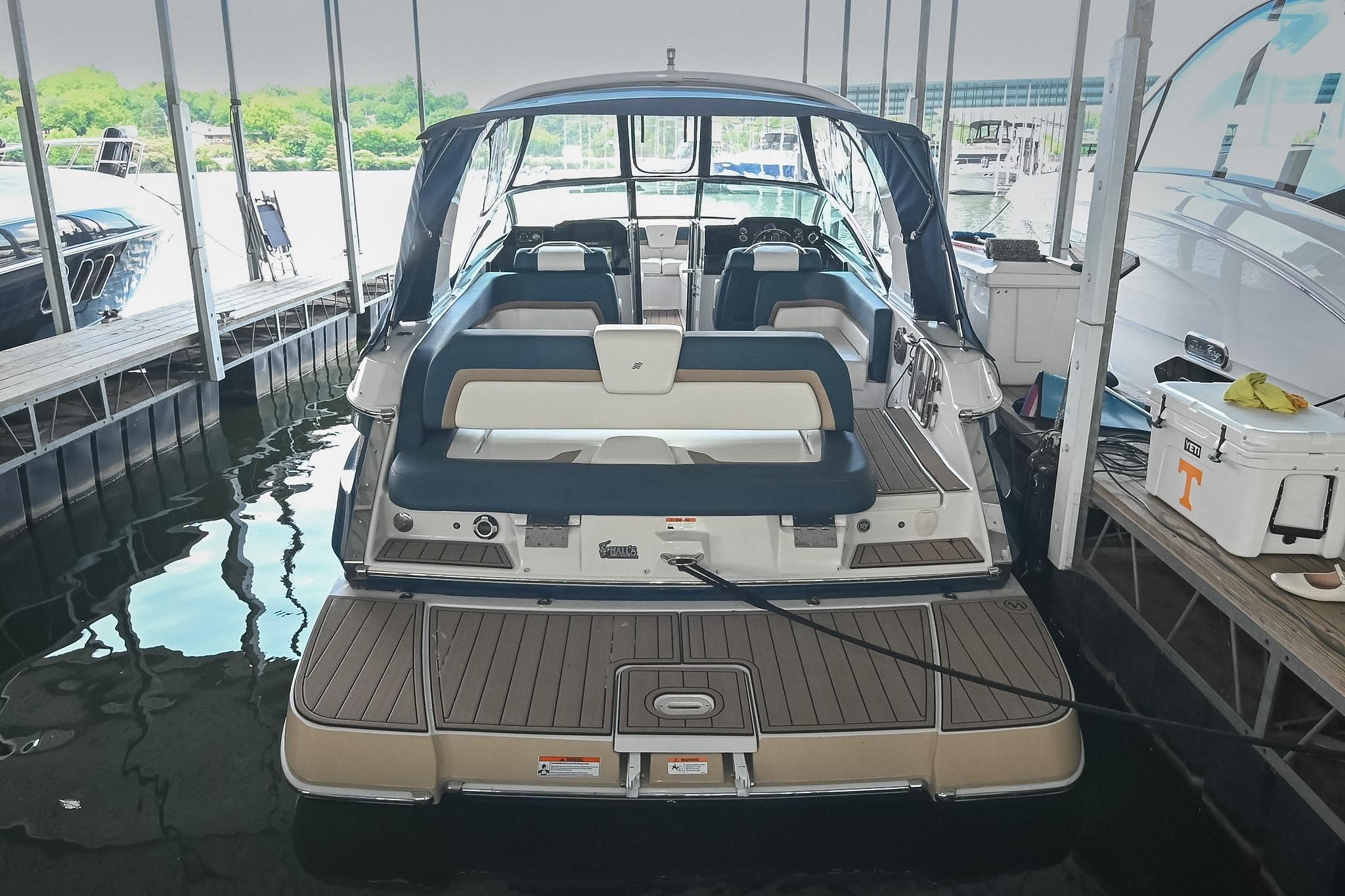 2014 Four Winns H290 boat docked, featuring spacious seating and sleek design.