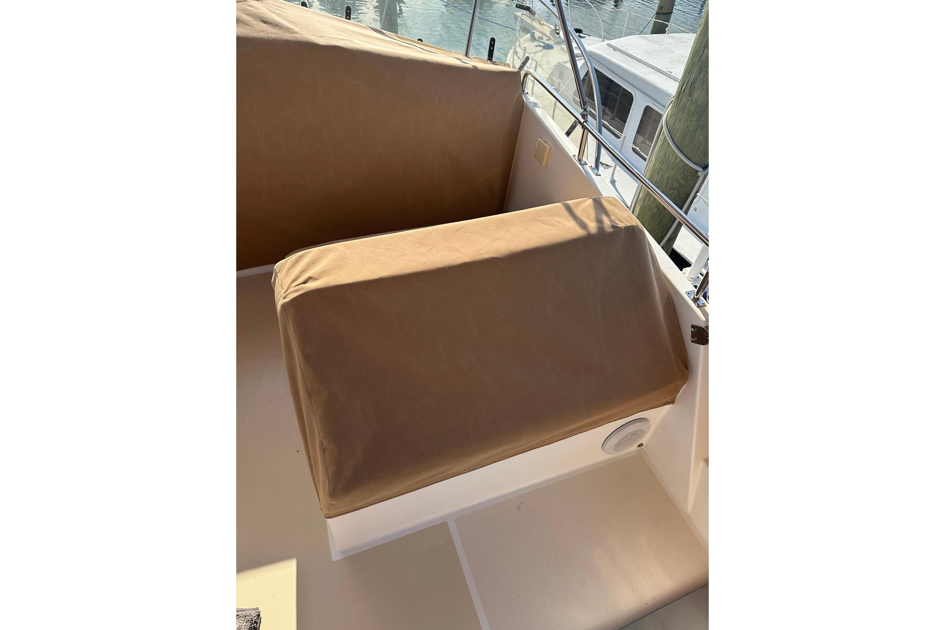 Brown-covered seating on 1999 Grand Banks 42 Europa yacht deck.