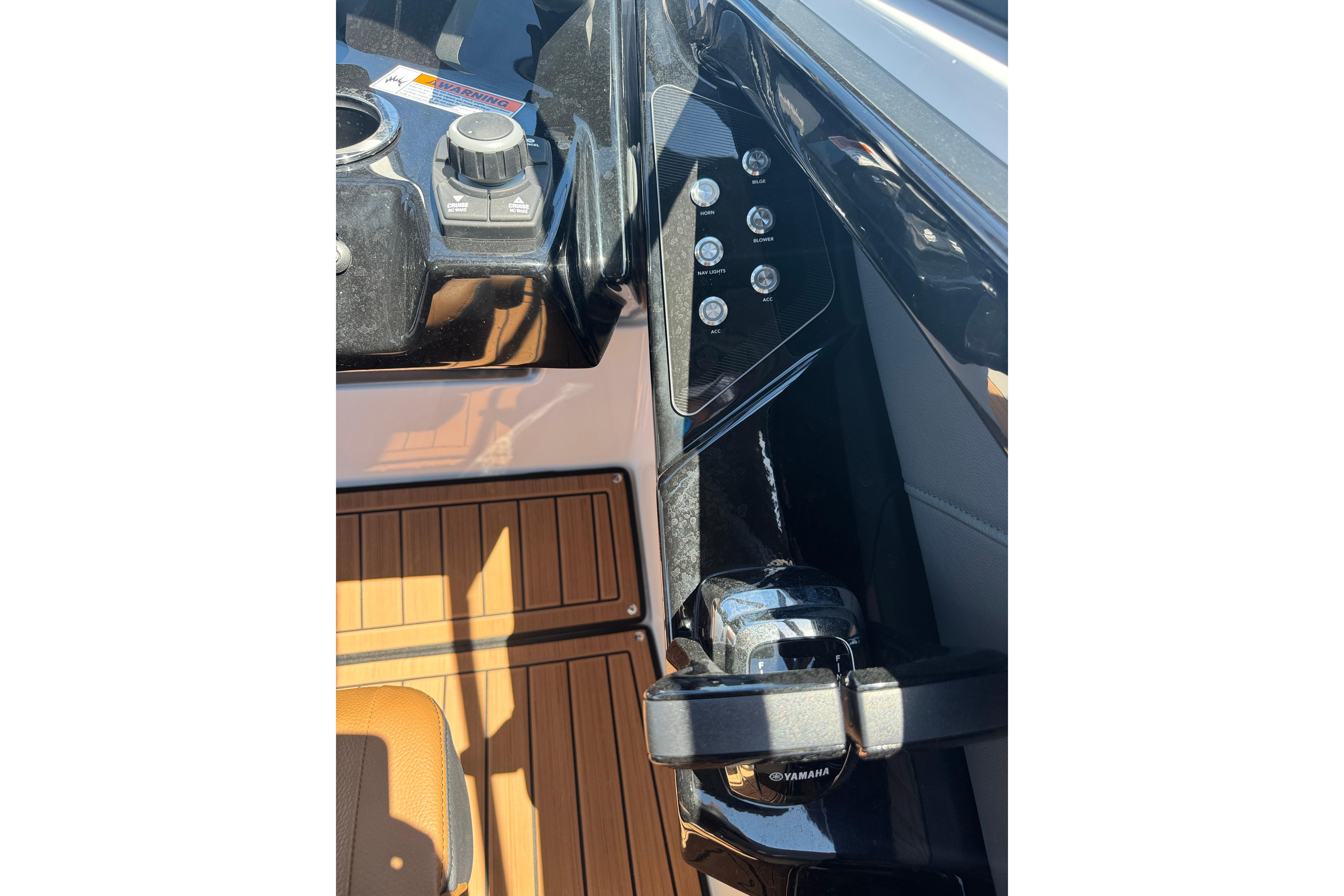 2026 Yamaha Boats 252SD dashboard with controls and wood paneling.