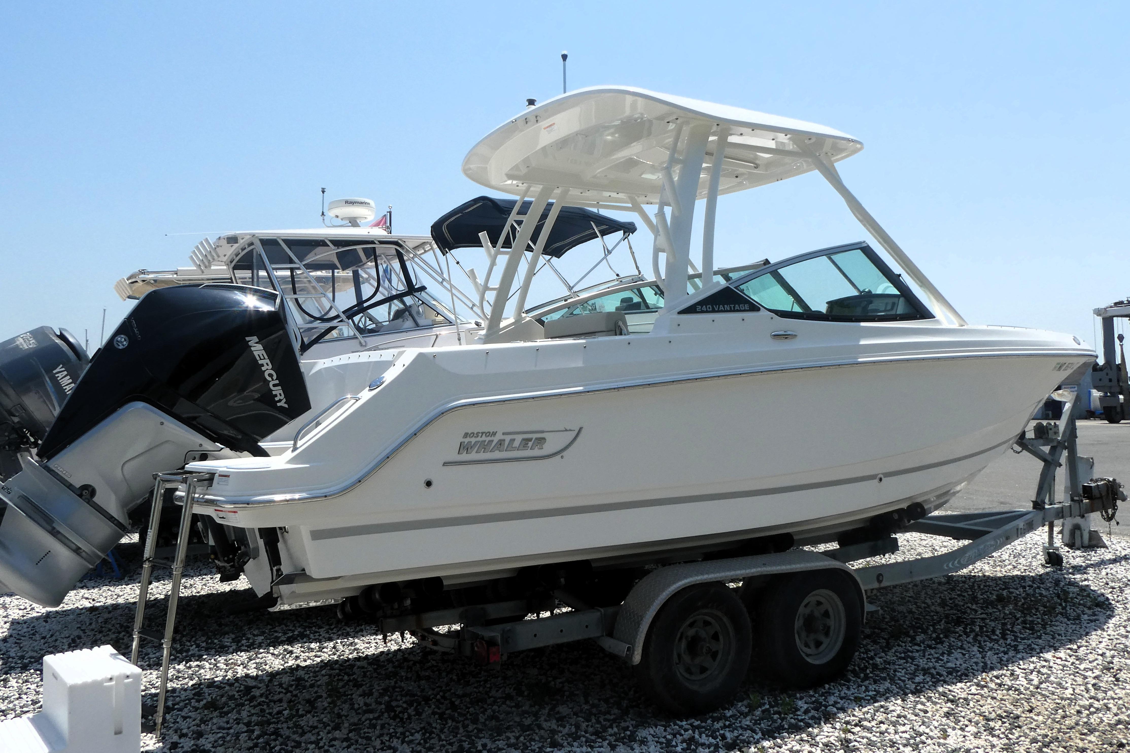 2022 Boston Whaler 240 Vantage boat on trailer, featuring sleek design and Mercury engine.