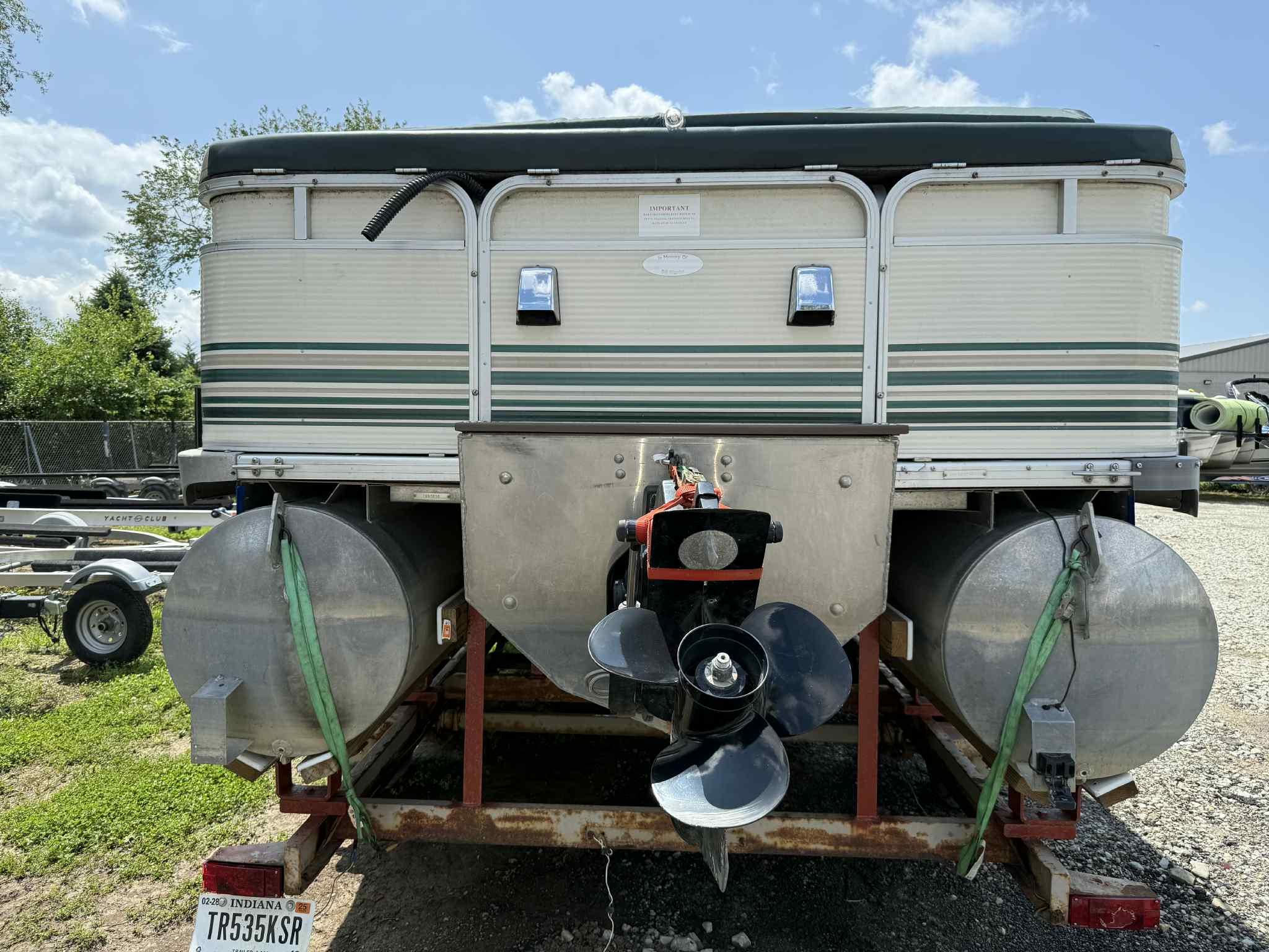 1999 Smoker Craft 8526 Pleasure Isle I/O pontoon boat, rear view with propeller and trailer.