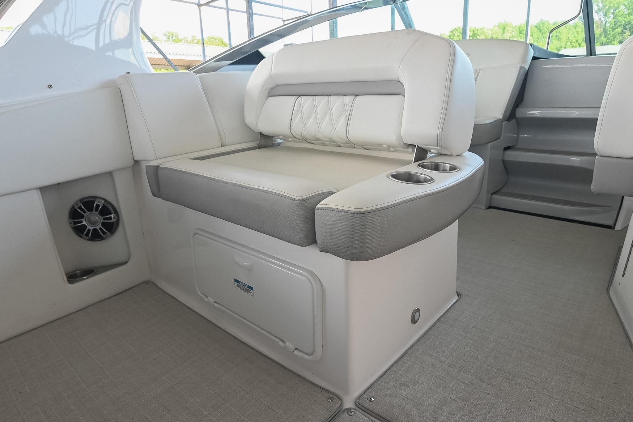 2021 Regal 33 Express boat interior with cushioned seating and cup holders.
