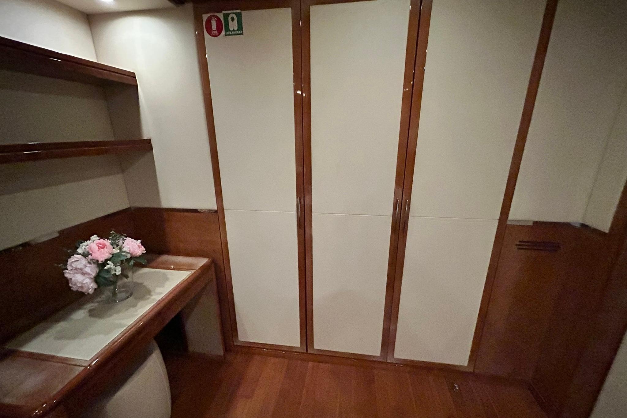 Luxurious interior of 2010 Versilcraft Euroyacht Planet 125S, featuring elegant wood finishes and floral decor.