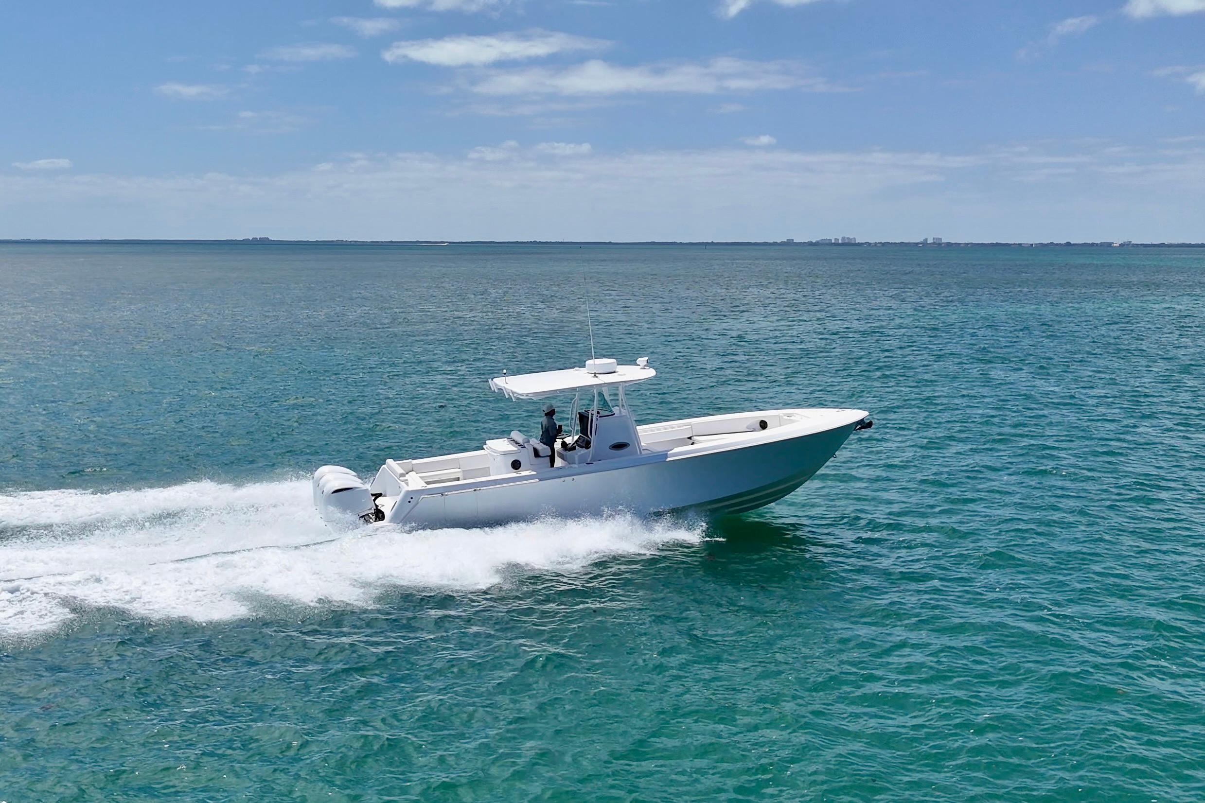 2013 Contender 35 LS boat cruising on open water under clear skies.