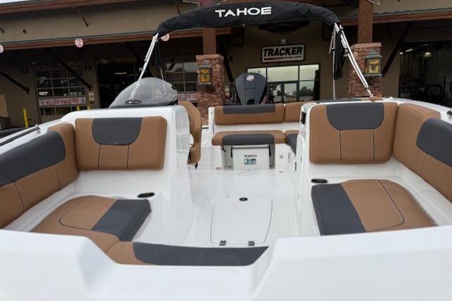 2026 Tahoe 1950 boat with spacious seating and modern design at a dealership.