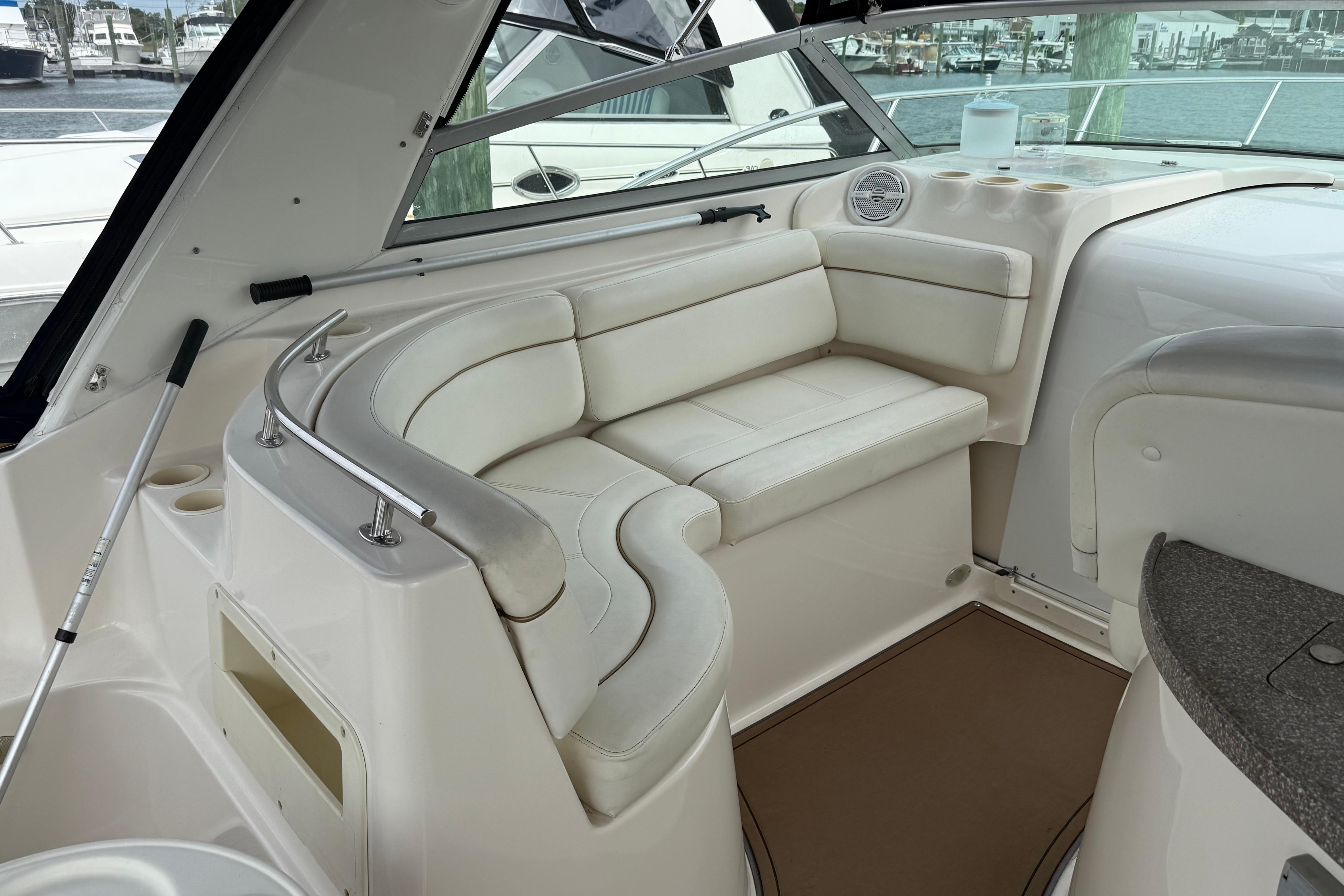 2004 Rinker 342 boat interior with white leather seating and cup holders.