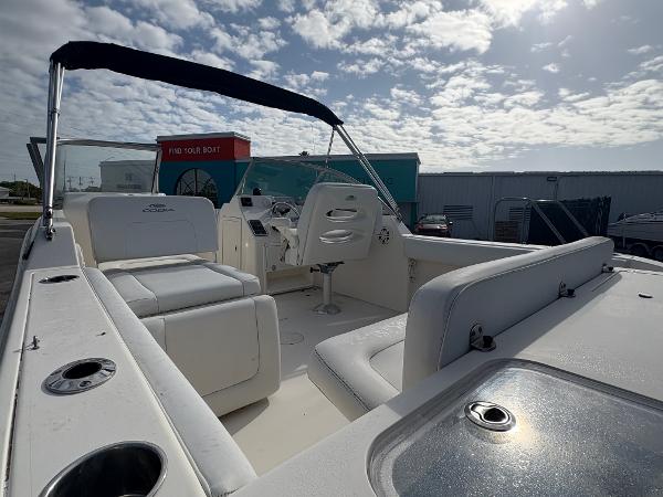 2020 Cobia 220 Dual Console boat with seating, under a partly cloudy sky.