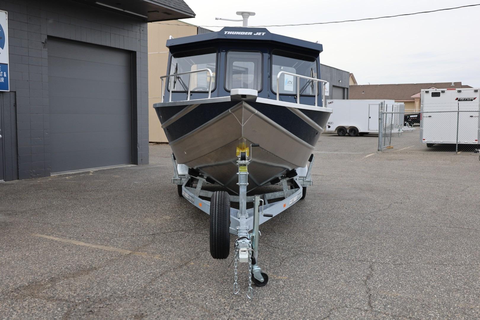 2026 Thunder Jet 24 Alexis Pro boat on trailer in parking lot.